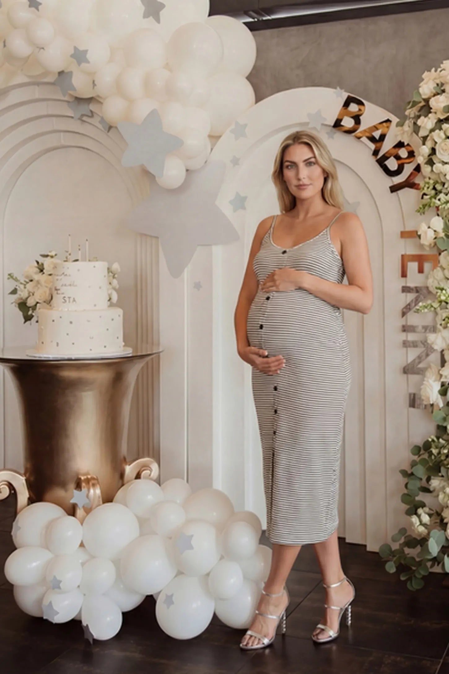 Sleeveless Button-Down Split Hem Midi Maternity Dress Sleeveless button-down split hem midi maternity dress in gray and white stripes with chic striped silhouette, on editorial lifestyle model