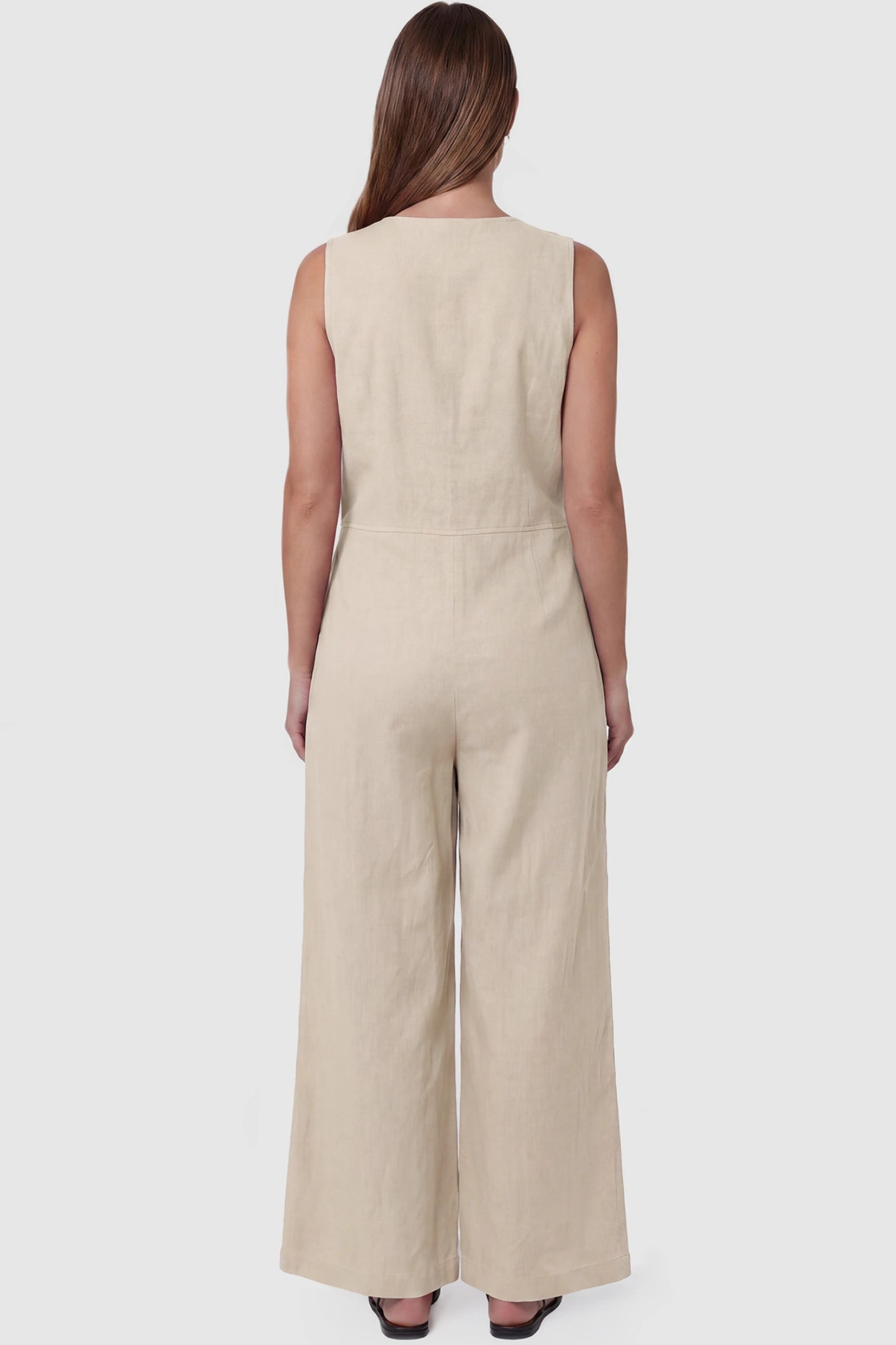 Wide-Leg V-Neck Button-Front Maternity Jumpsuit Wide-leg V-neck button-front maternity jumpsuit in beige with sleeveless cut, back view on pregnant model