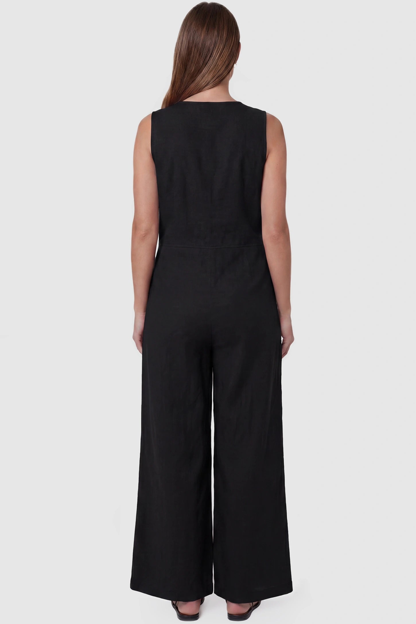 Wide-Leg V-Neck Button-Front Maternity Jumpsuit Wide-leg V-neck button-front maternity jumpsuit in black with sleeveless cut, back view on pregnant model
