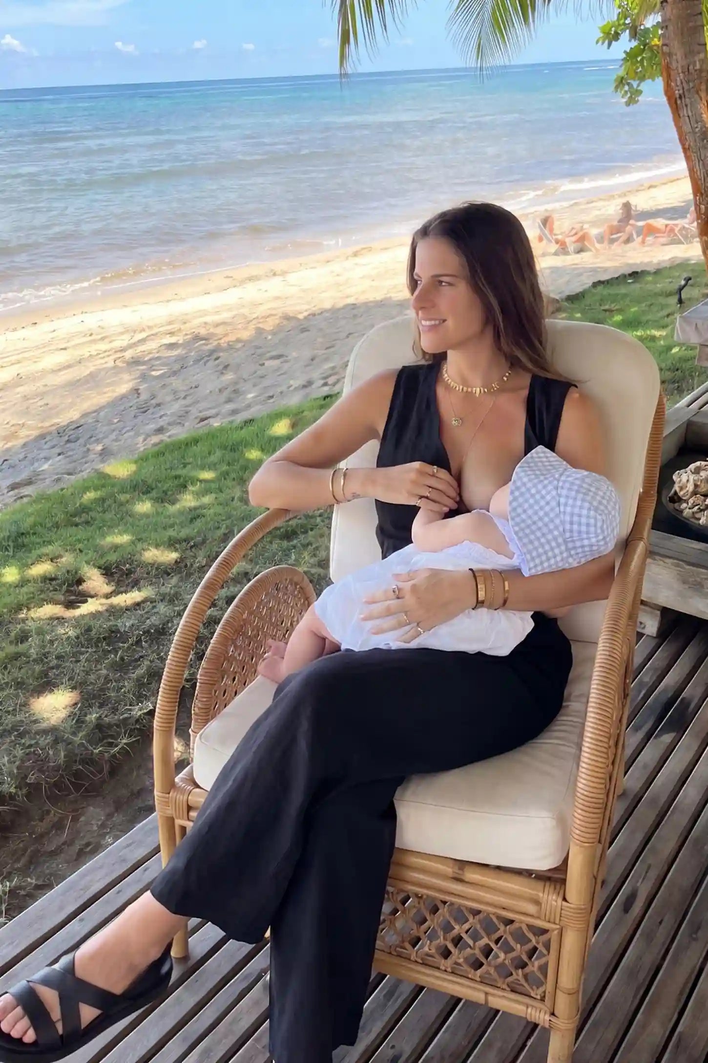 Wide-Leg V-Neck Button-Front Maternity Jumpsuit Wide-leg V-neck button-front maternity jumpsuit in black with discreet nursing access, front view on pregnant model