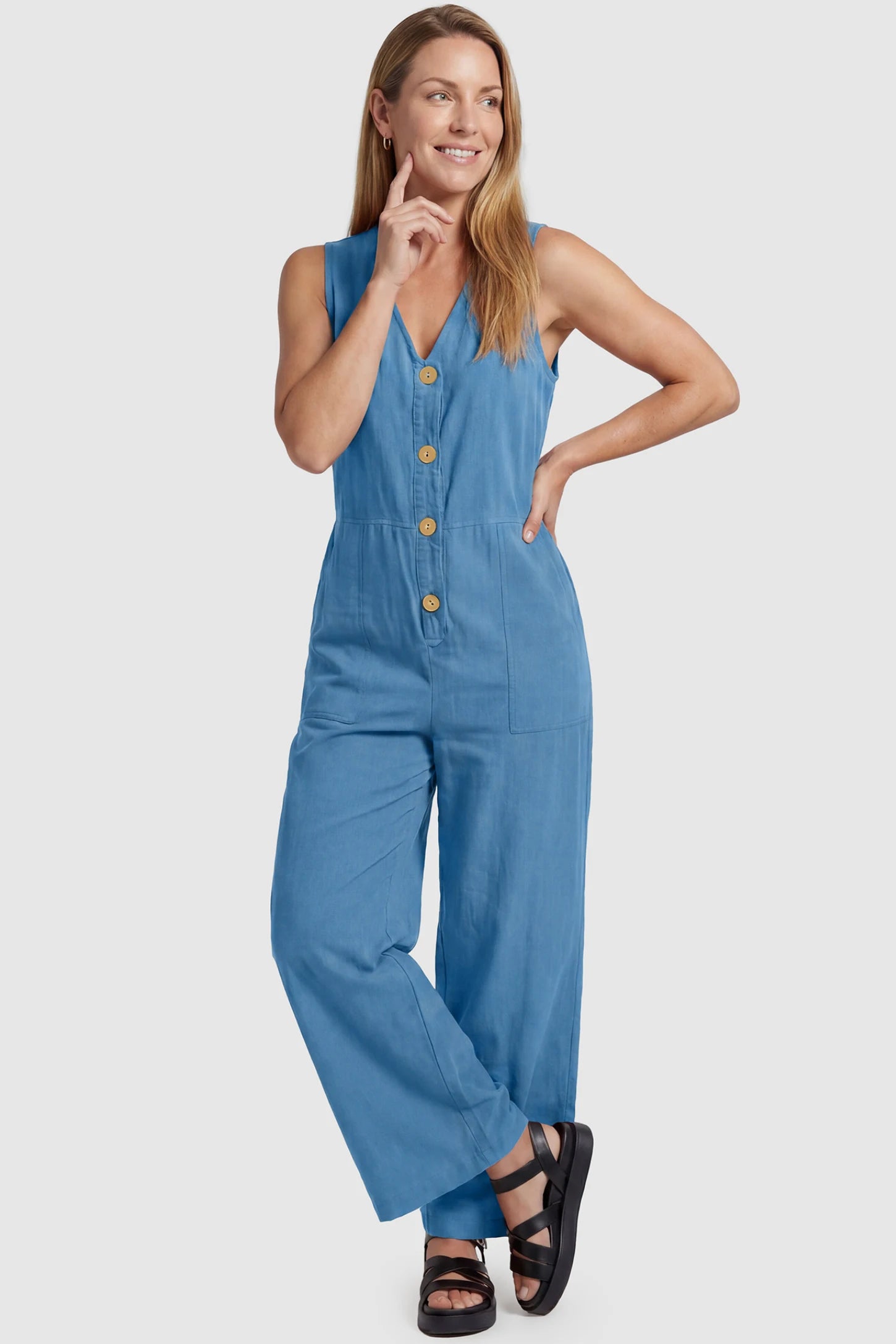 Wide-Leg V-Neck Button-Front Maternity Jumpsuit Wide-leg V-neck button-front maternity jumpsuit in blue with sleeveless V-neckline and button-front detail, front view on postpartum model