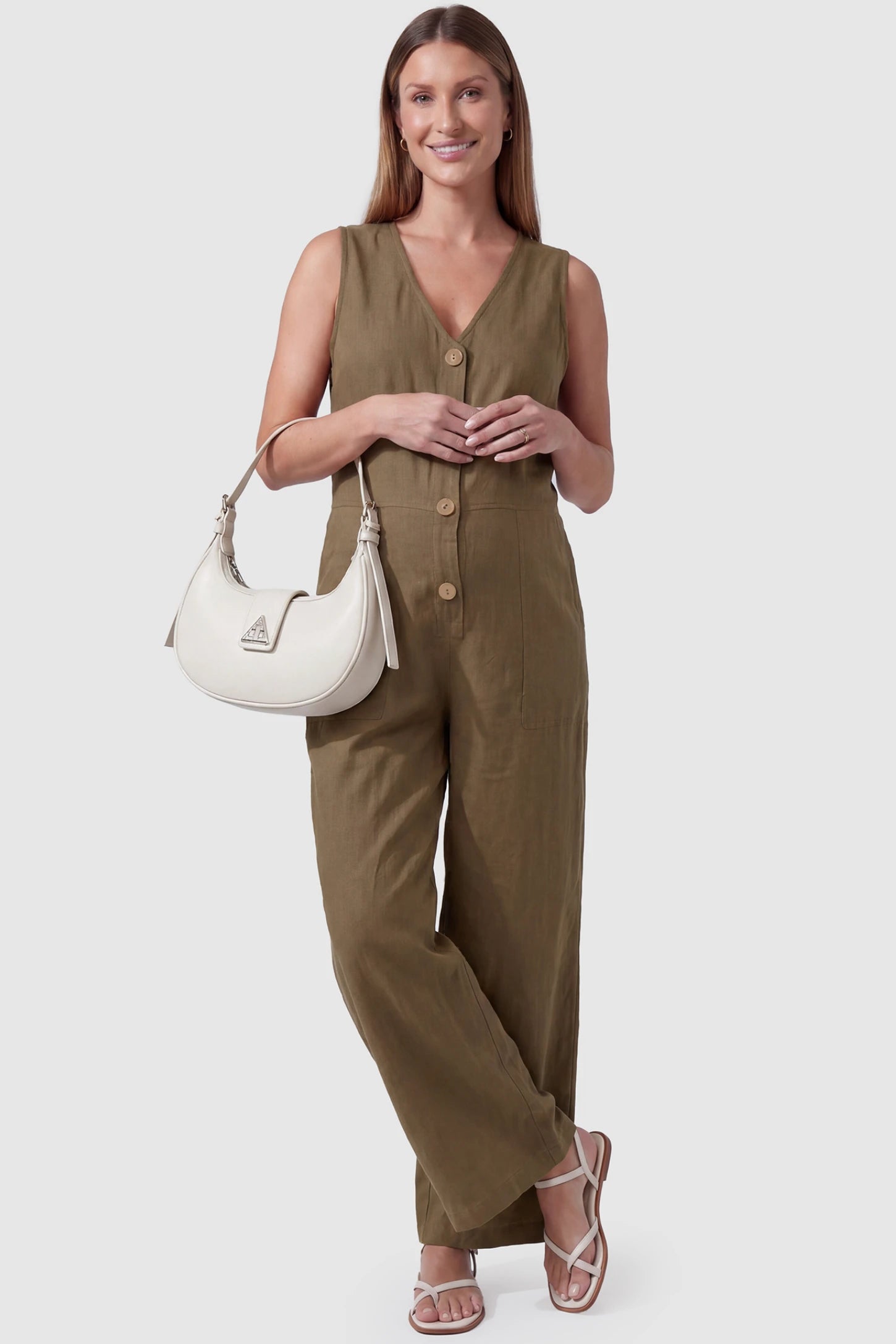 Wide-Leg V-Neck Button-Front Maternity Jumpsuit Wide-leg V-neck button-front maternity jumpsuit in brown with sleeveless V-neckline and button-front detail, front view on pregnant model