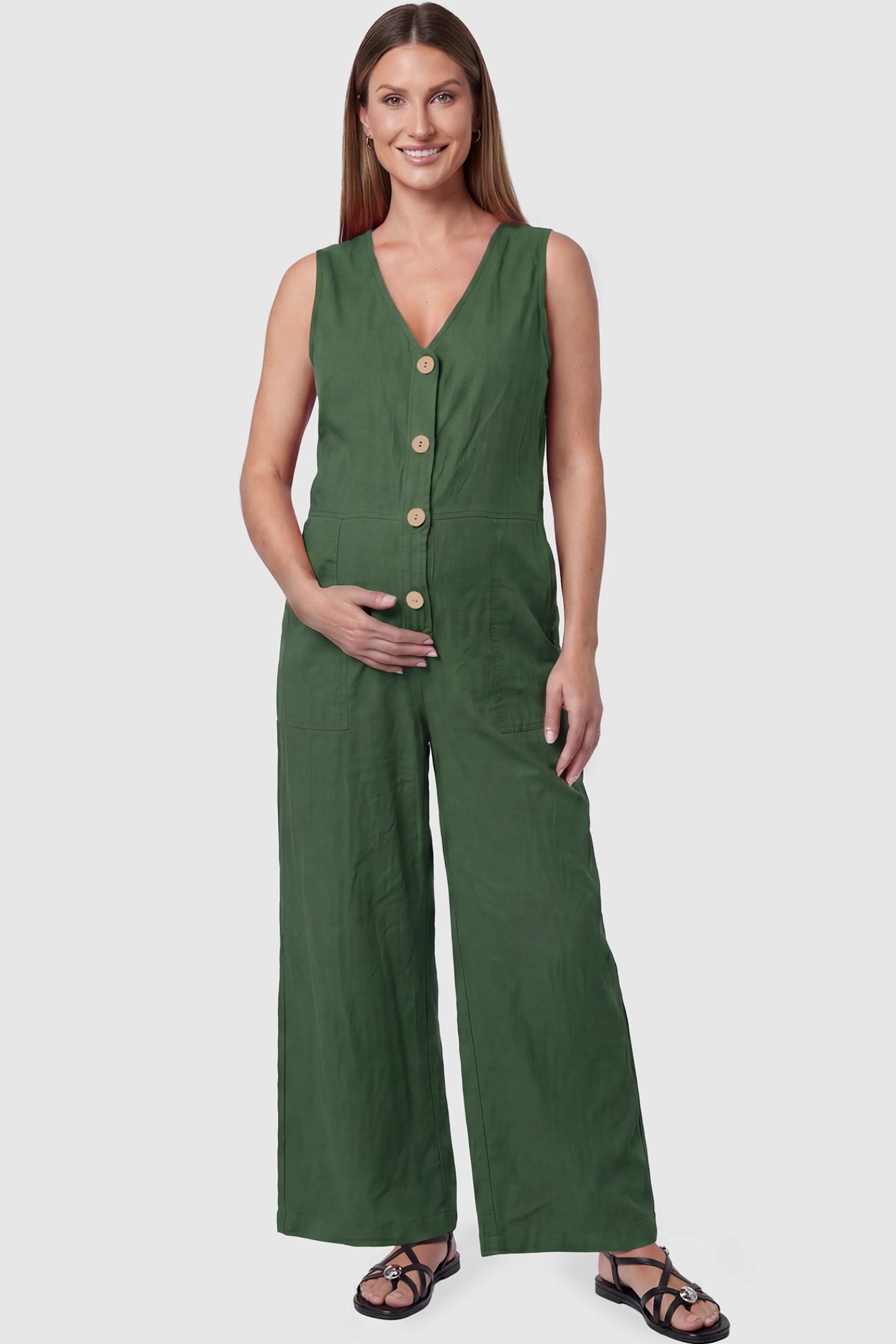 Wide-Leg V-Neck Button-Front Maternity Jumpsuit Wide-leg V-neck button-front maternity jumpsuit in green with sleeveless V-neckline and button-front detail, front view on pregnant model