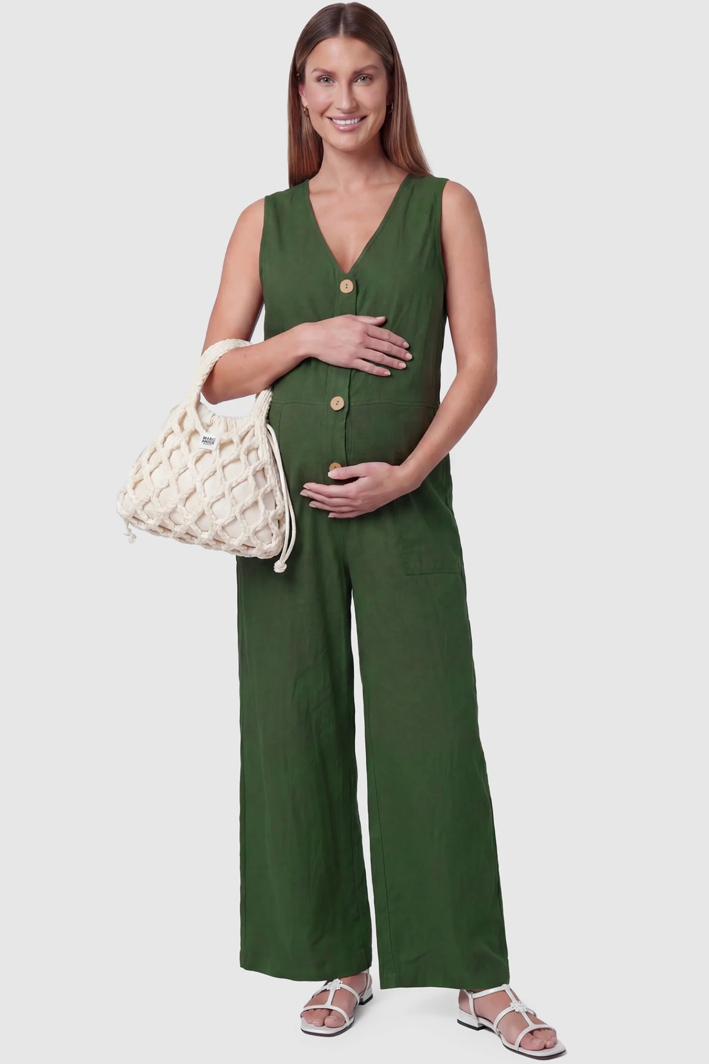Wide-Leg V-Neck Button-Front Maternity Jumpsuit Wide-leg V-neck button-front maternity jumpsuit in green with sleeveless V-neckline and button-front detail, front view on pregnant model
