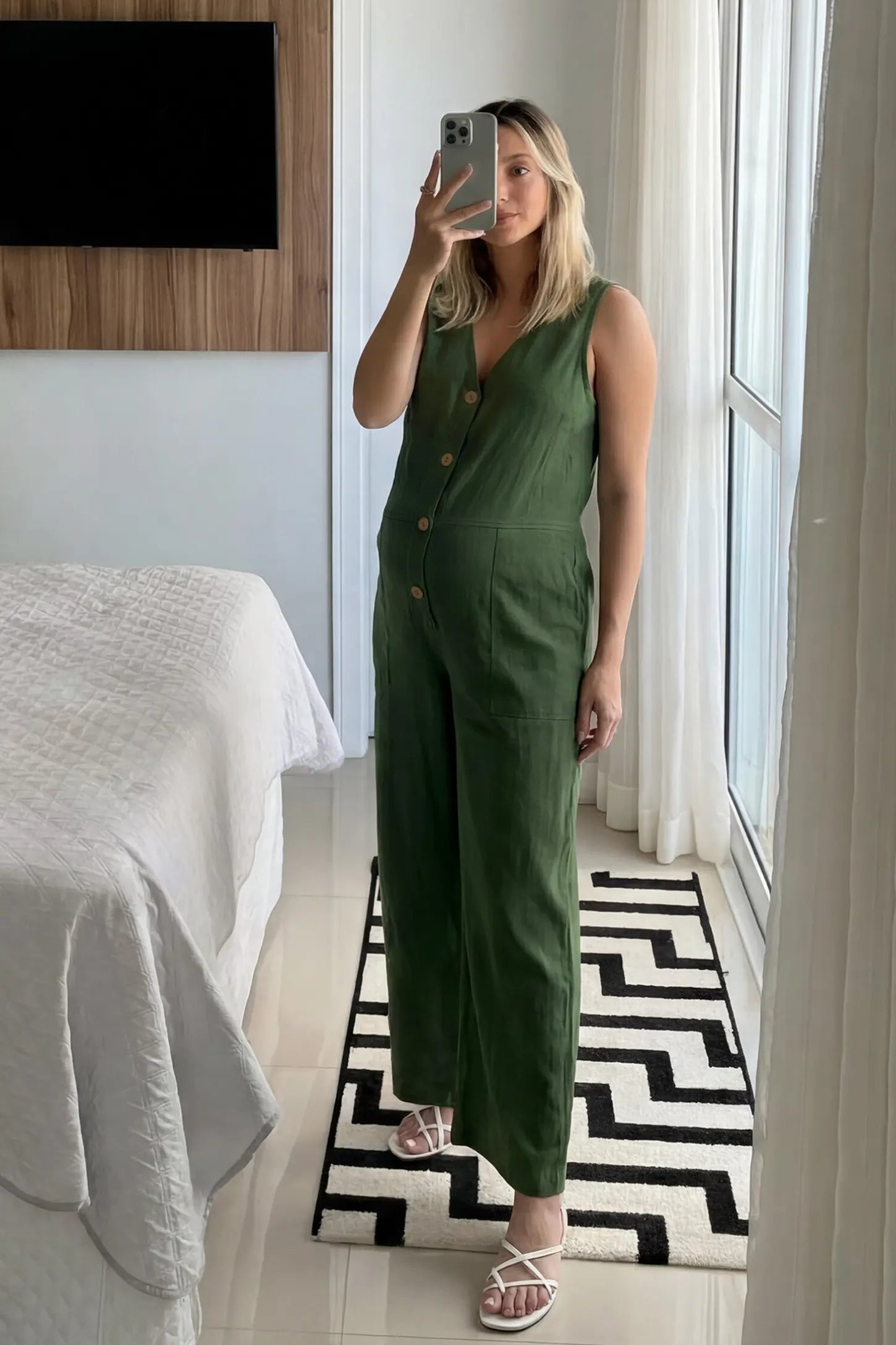 Wide-Leg V-Neck Button-Front Maternity Jumpsuit Wide-leg V-neck button-front maternity jumpsuit in green with sleeveless V-neckline and button-front detail, front view on pregnant model