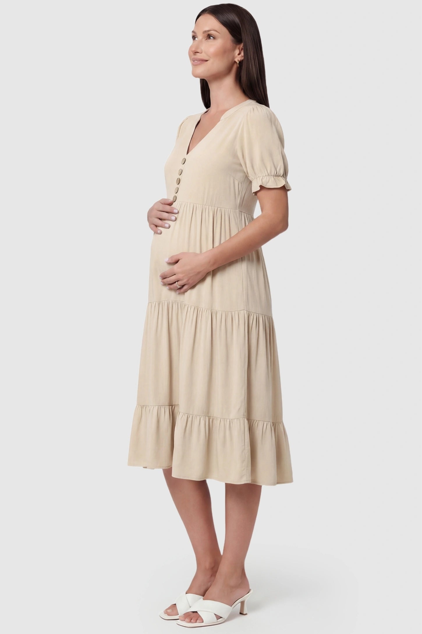 Button-Front Tiered Maternity Midi Dress Button-Front Tiered Maternity Midi Dress in Apricot featuring a high-waisted silhouette and tiered skirt on a pregnant model.