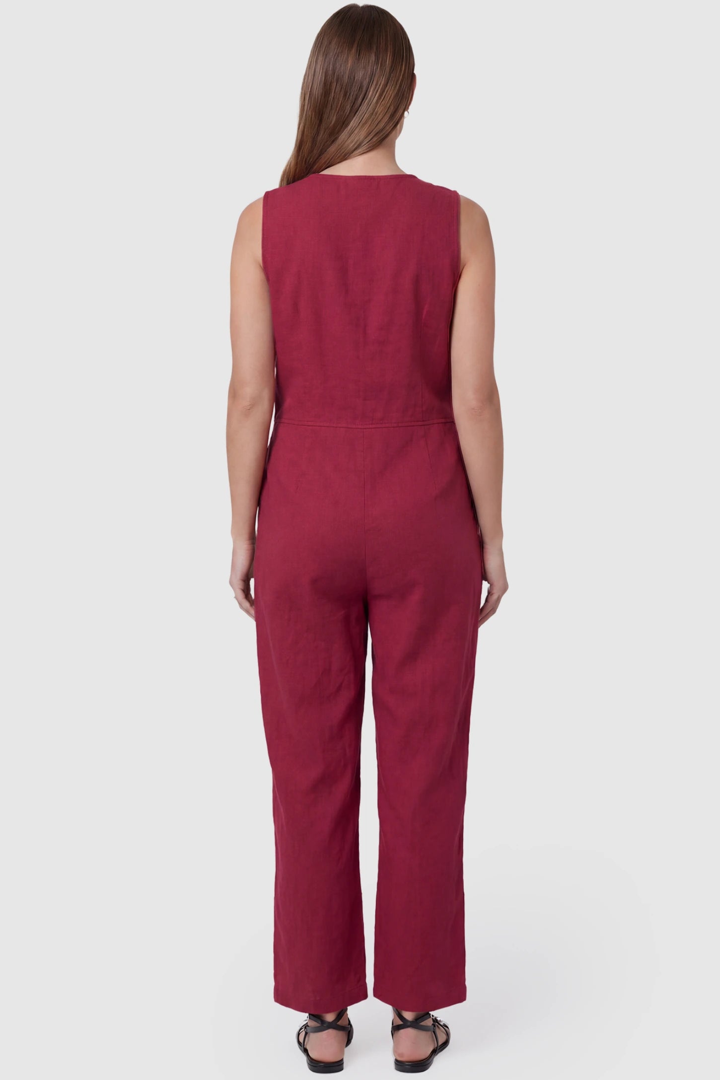 Wide-Leg V-Neck Button-Front Maternity Jumpsuit Wide-leg V-neck button-front maternity jumpsuit in wine red with sleeveless cut, back view on pregnant model