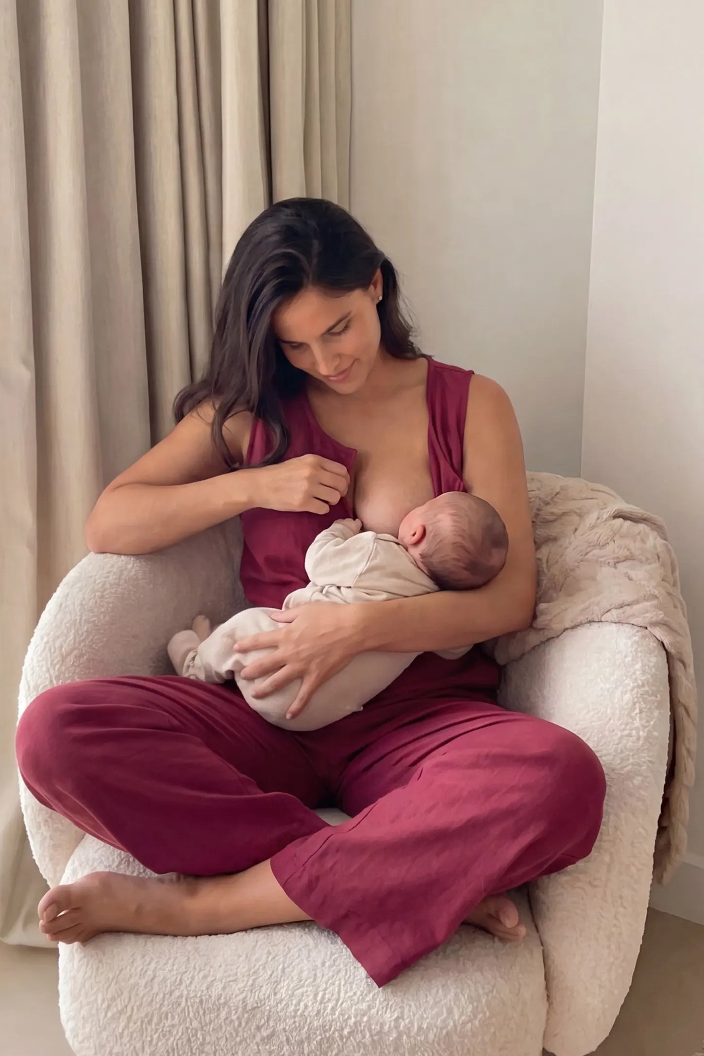 Wide-Leg V-Neck Button-Front Maternity Jumpsuit Wide-leg V-neck button-front maternity jumpsuit in wine red with discreet nursing access, front view on pregnant model