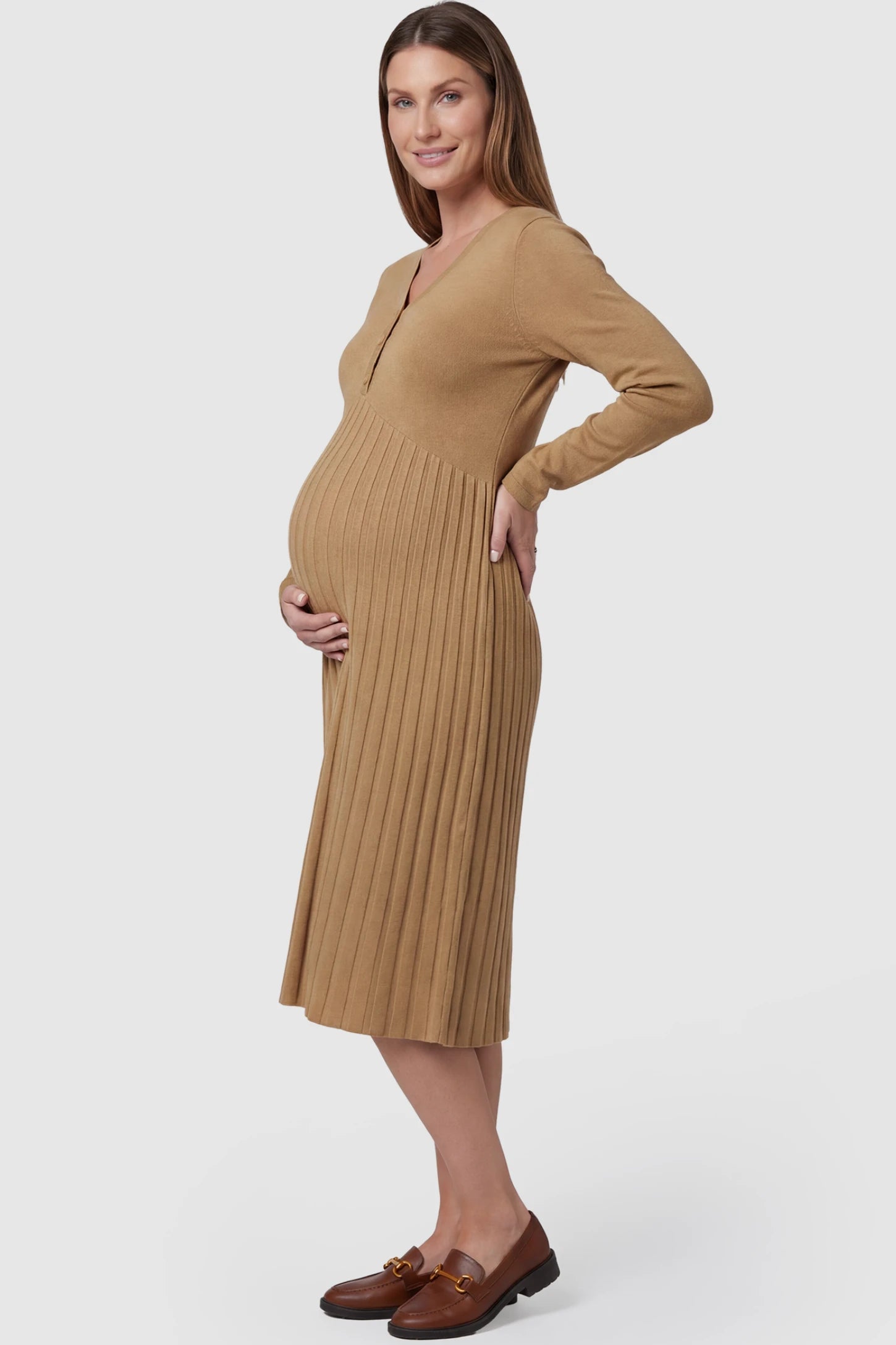Button-Up Empire Waist Maternity Midi Dress Button-up empire waist maternity midi dress in beige with soft pleated detail, side view on pregnant model