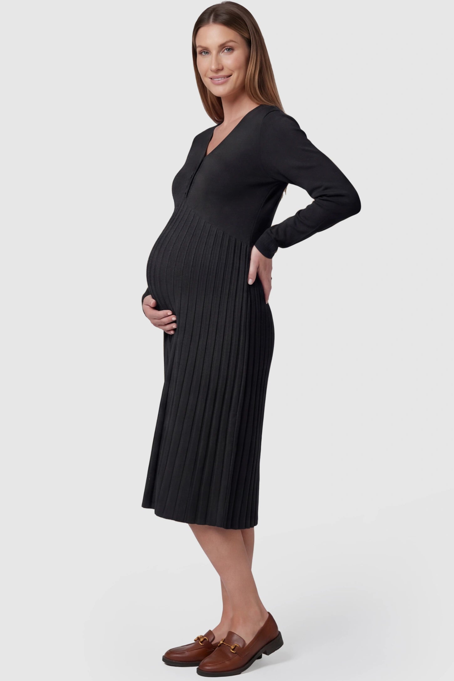 Button-Up Empire Waist Maternity Midi Dress Button-up empire waist maternity midi dress in black with soft pleated detail, side view on pregnant model