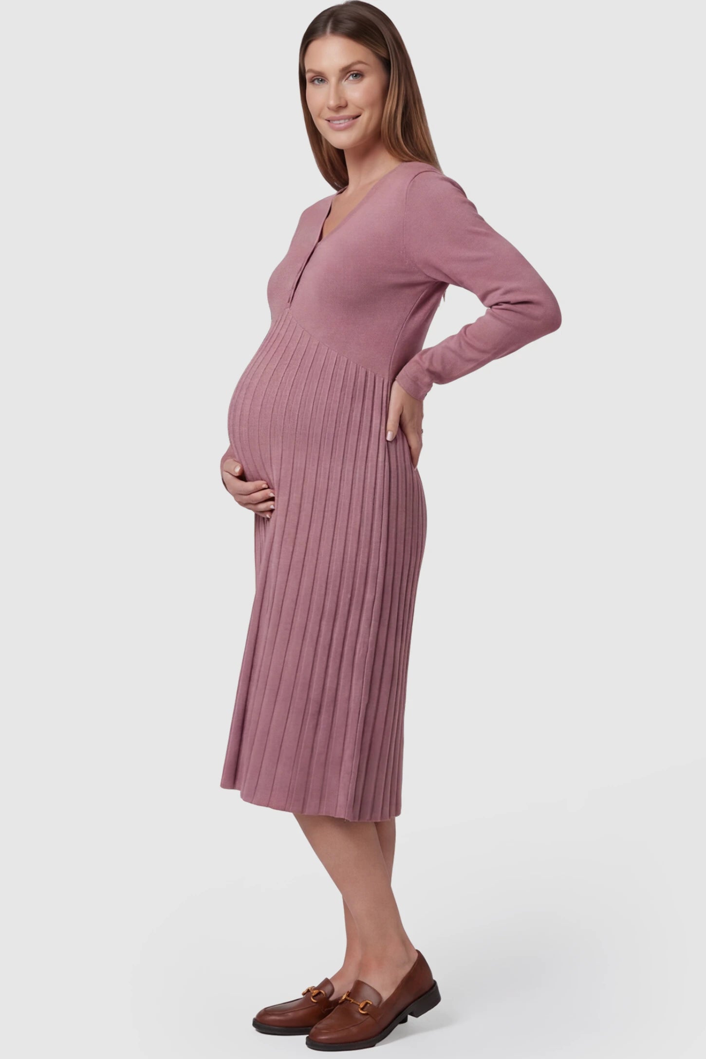 Button-Up Empire Waist Maternity Midi Dress Button-up empire waist maternity midi dress in pink with soft pleated detail, side view on pregnant model