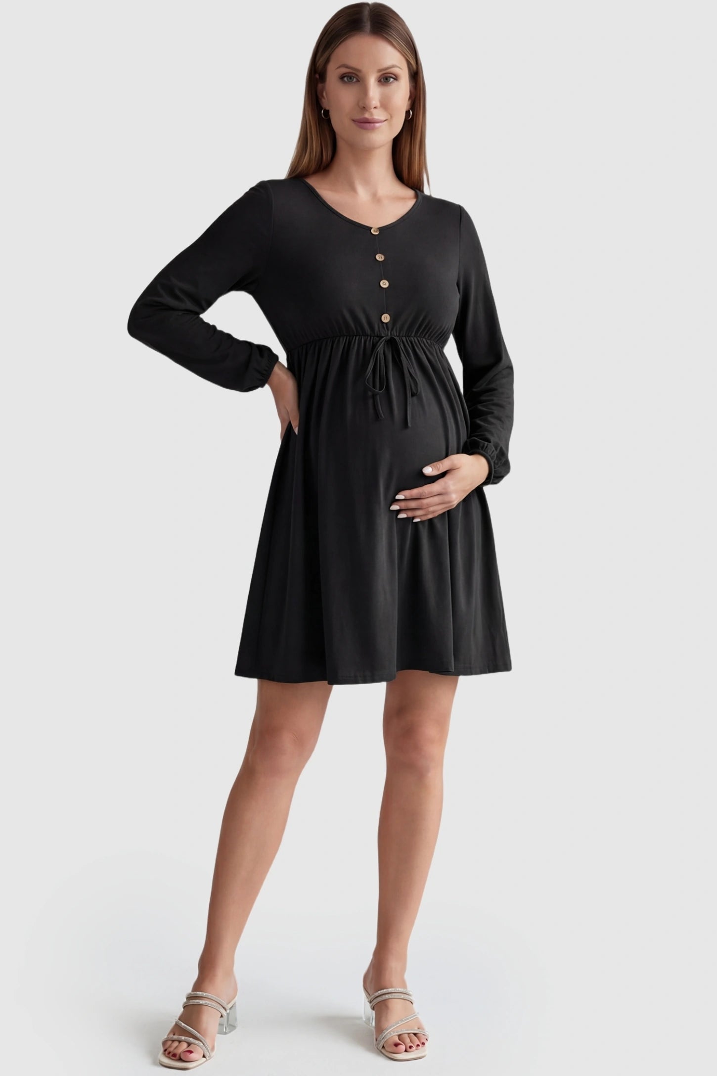 Button-Front Drawstring Waist Maternity Mini Dress Button-Front Drawstring Waist Maternity Mini Dress in Black featuring a gathered waist on a pregnant model, front view.