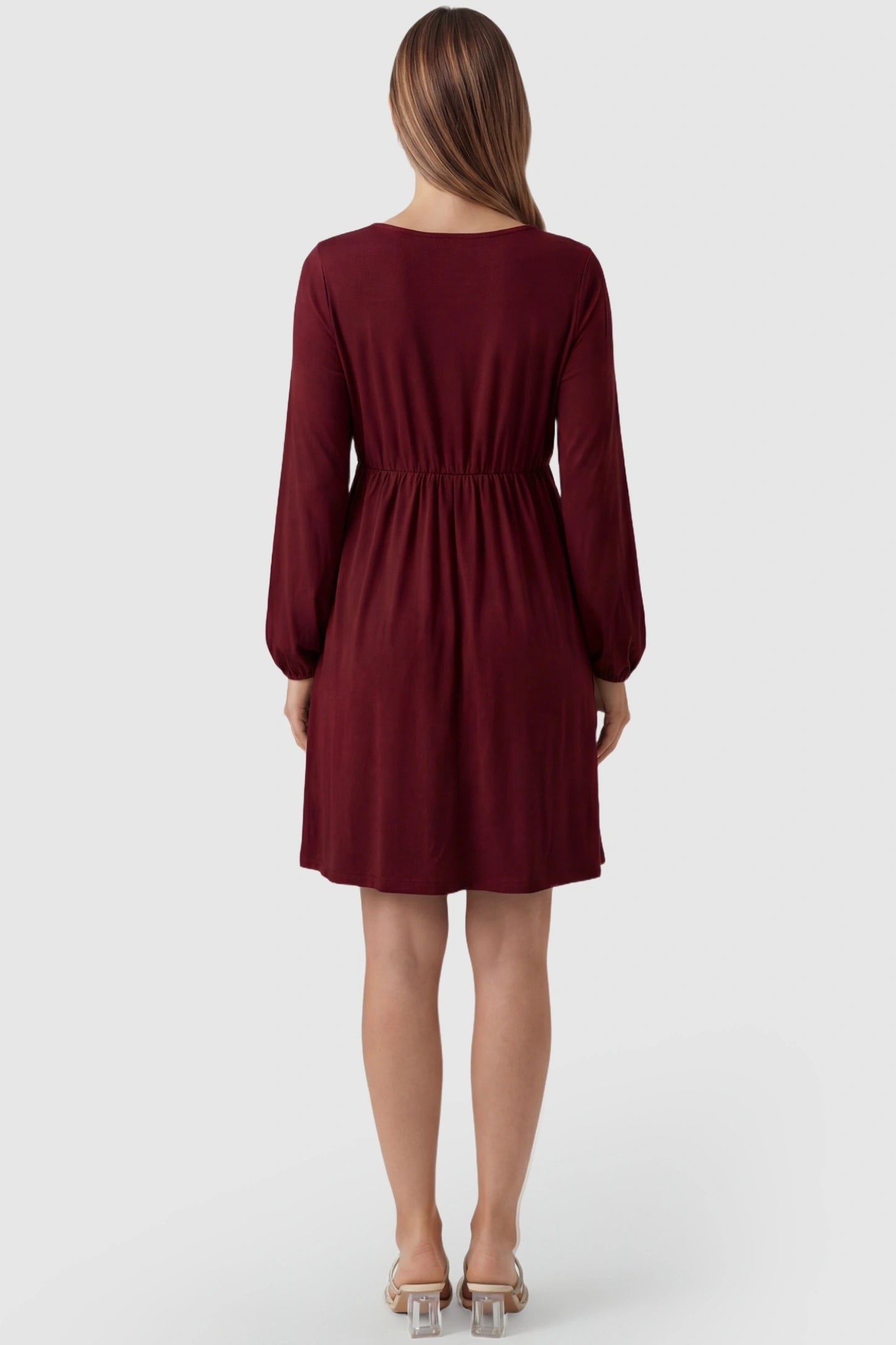 Button-Front Drawstring Waist Maternity Mini Dress Button-Front Drawstring Waist Maternity Mini Dress in Wine Red featuring a high-waisted round neck design on a pregnant model, back view.