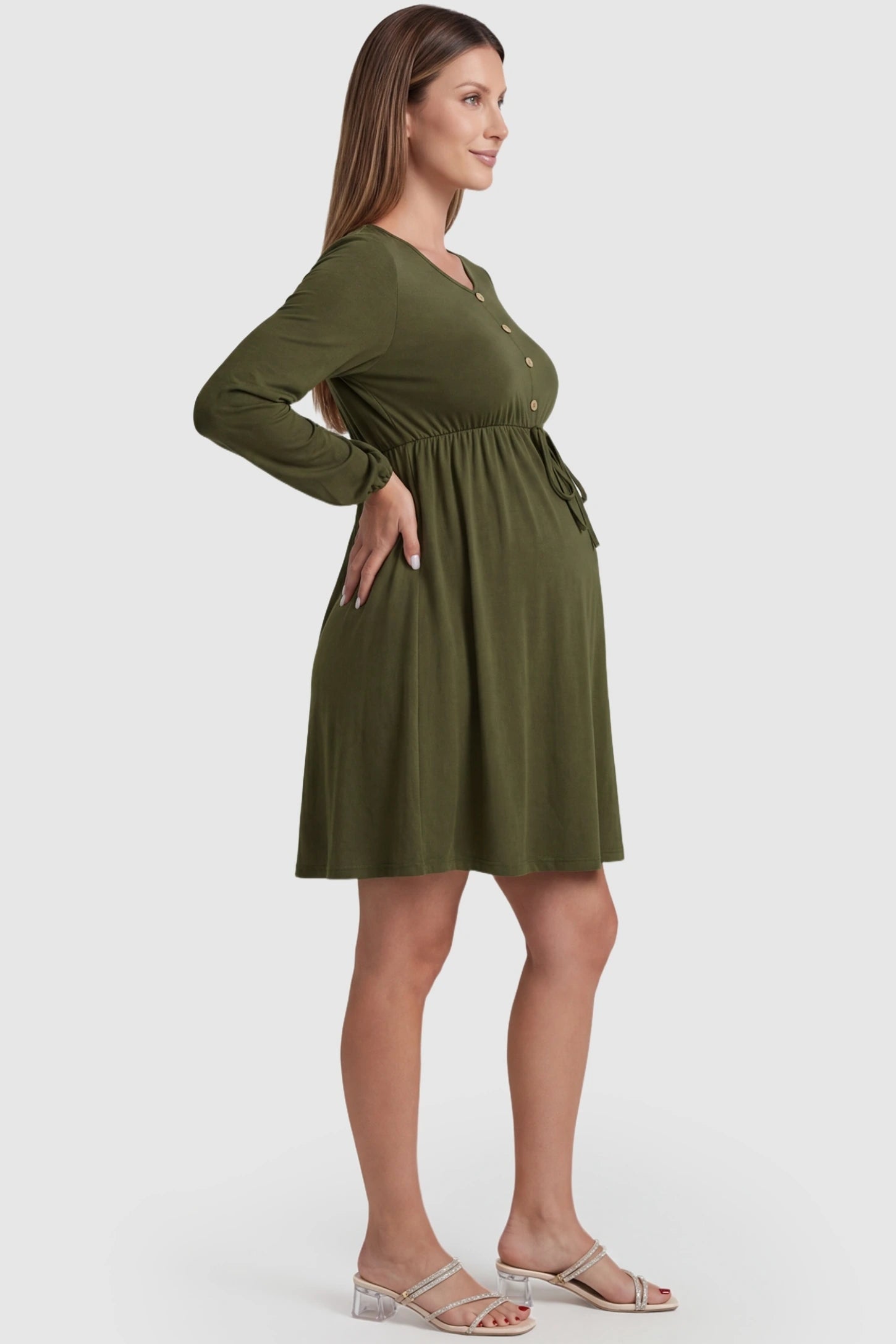 Button-Front Drawstring Waist Maternity Mini Dress Button-Front Drawstring Waist Maternity Mini Dress in Army Green featuring a stretchy A-line skirt on a pregnant model, side view.