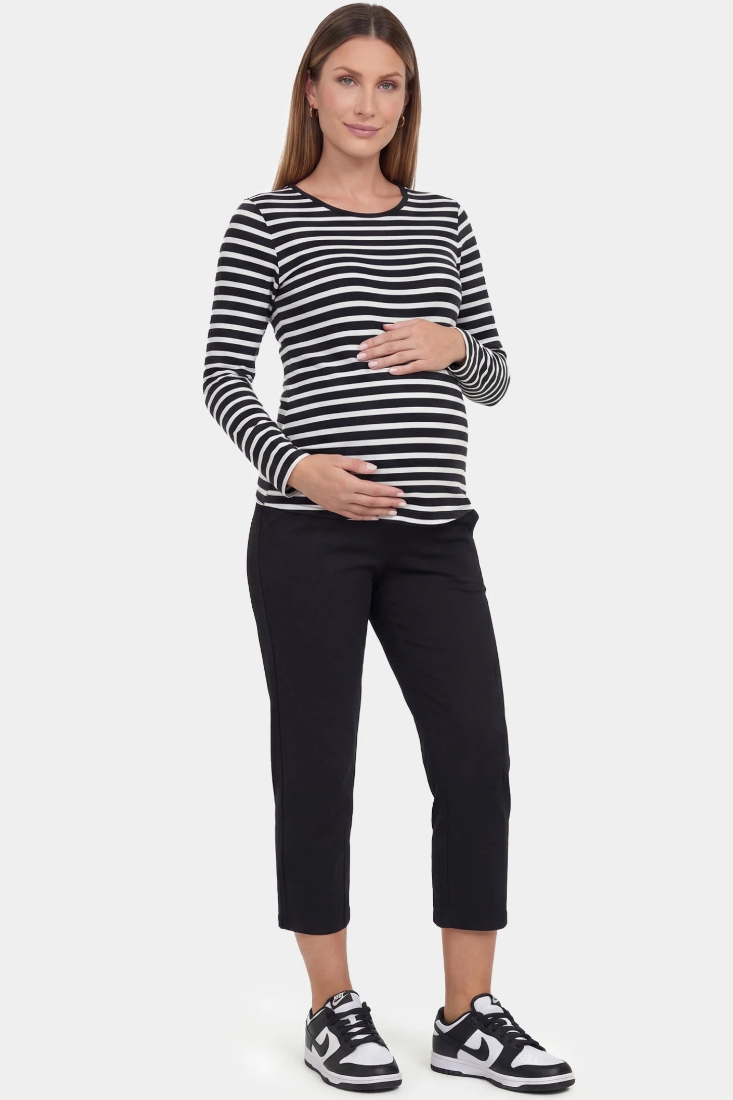 High-waist belly support loose-fit capri maternity pants in black with relaxed silhouette, full body on pregnant model