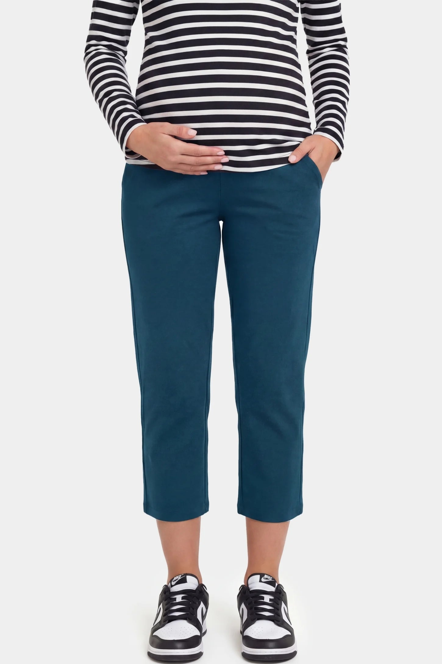 High-Waist Belly Support Loose-Fit Capri Maternity Pants High-waist belly support loose-fit capri maternity pants in blue with functional side pockets, front view on pregnant model