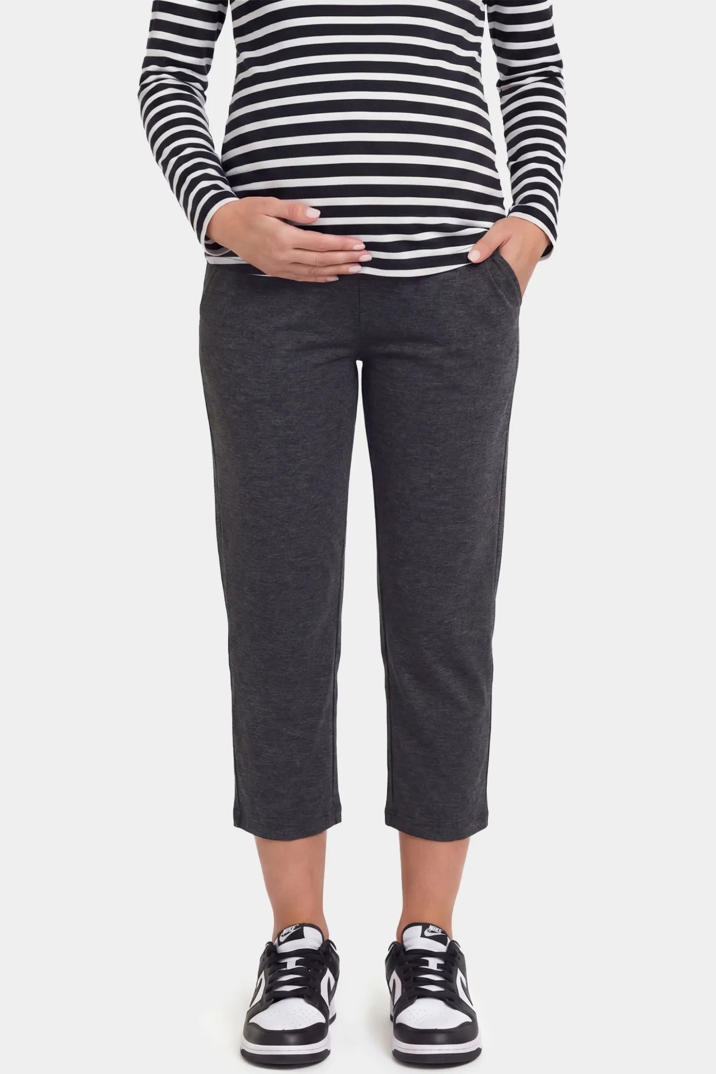 High-Waist Belly Support Loose-Fit Capri Maternity Pants High-waist belly support loose-fit capri maternity pants in dark gray with functional side pockets, front view on pregnant model