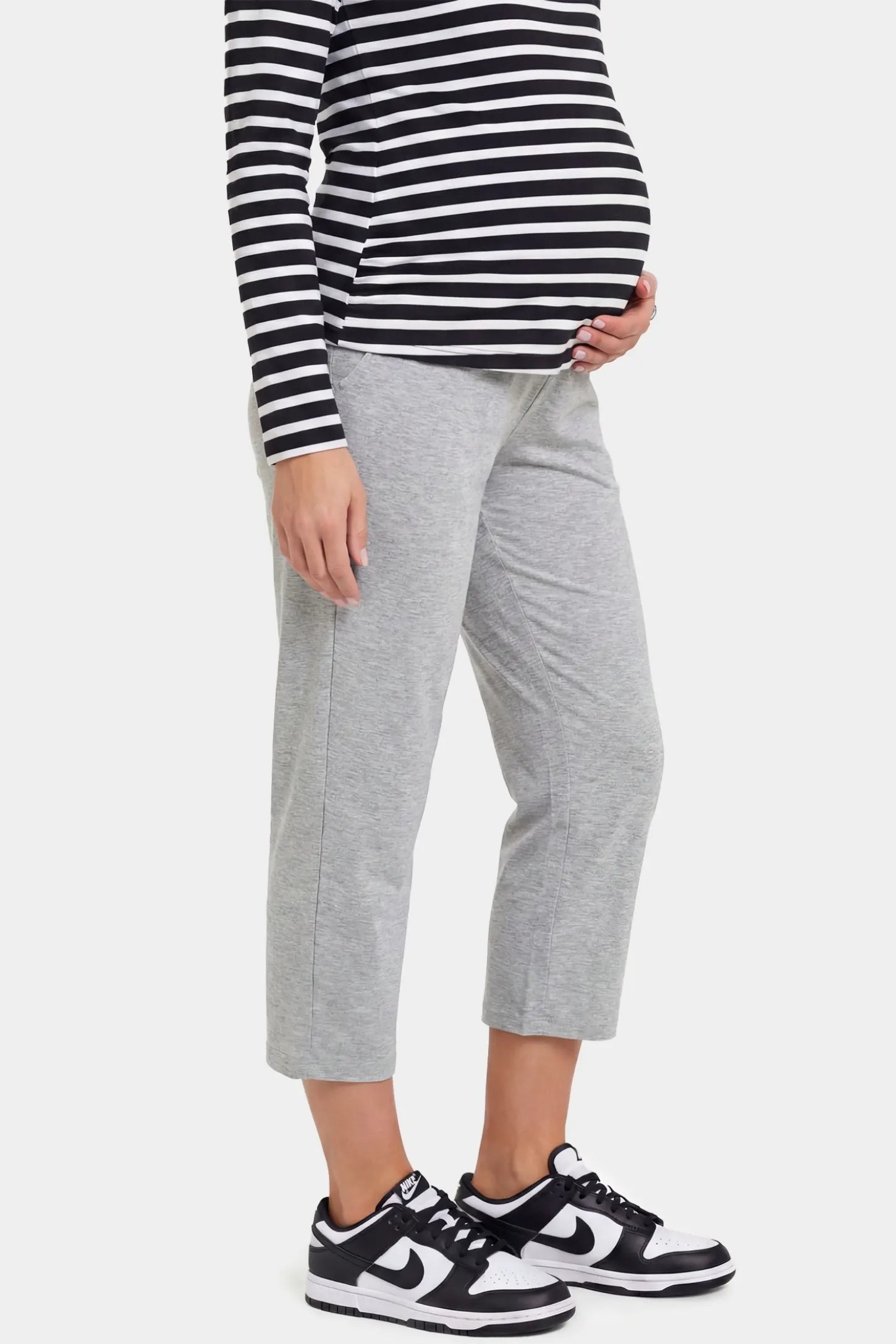 High-Waist Belly Support Loose-Fit Capri Maternity Pants High-waist belly support loose-fit capri maternity pants in light gray with cropped length, side view on pregnant model