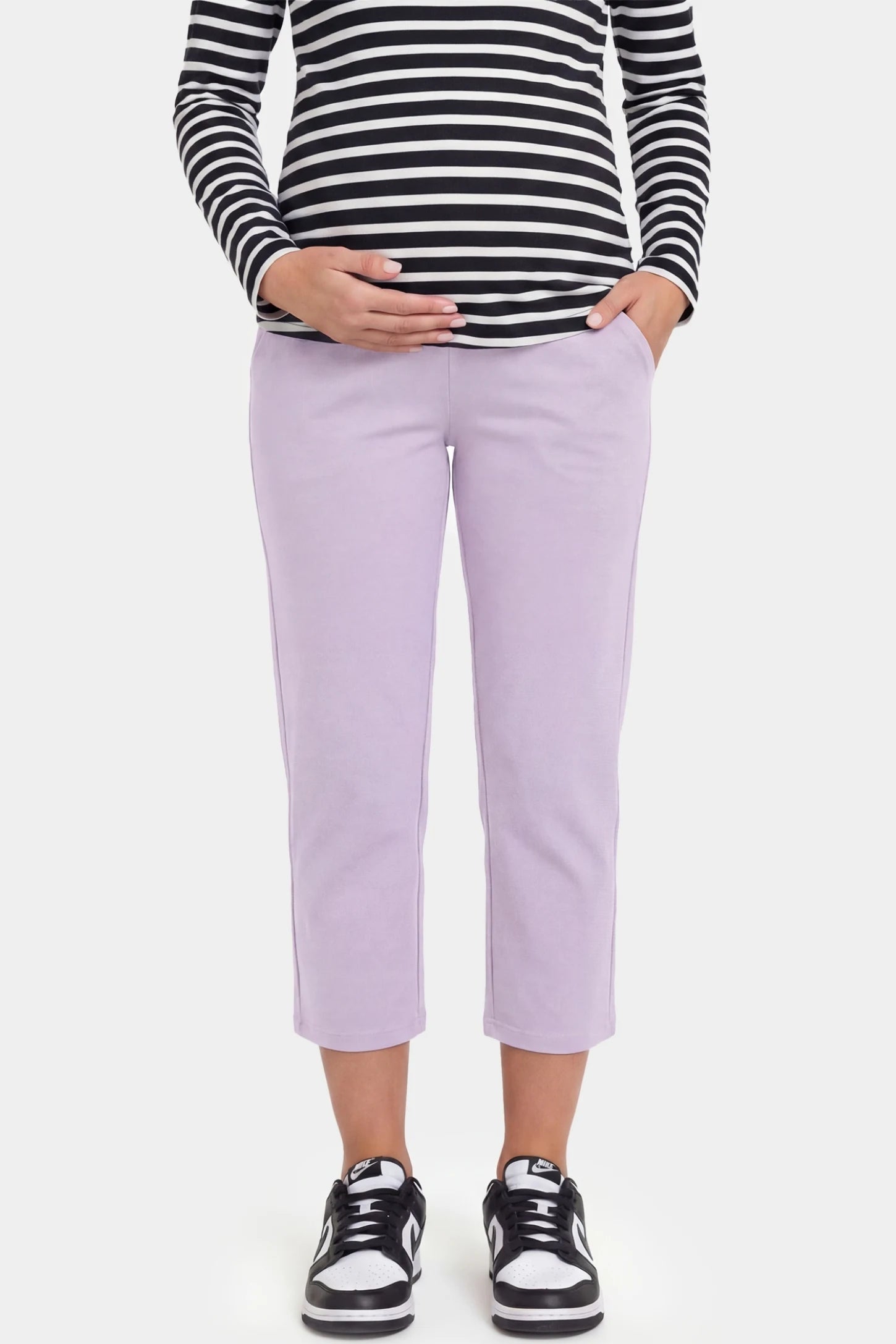 High-Waist Belly Support Loose-Fit Capri Maternity Pants High-waist belly support loose-fit capri maternity pants in light purple with functional side pockets, front view on pregnant model