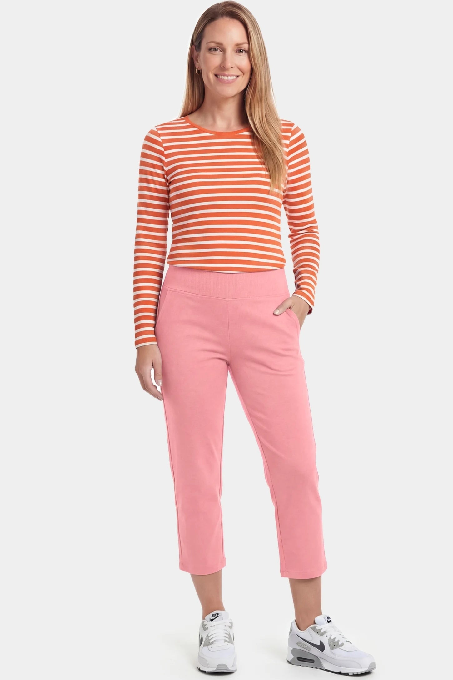 High-Waist Belly Support Loose-Fit Capri Maternity Pants High-waist belly support loose-fit capri maternity pants in pink with functional side pockets, full body on postpartum model