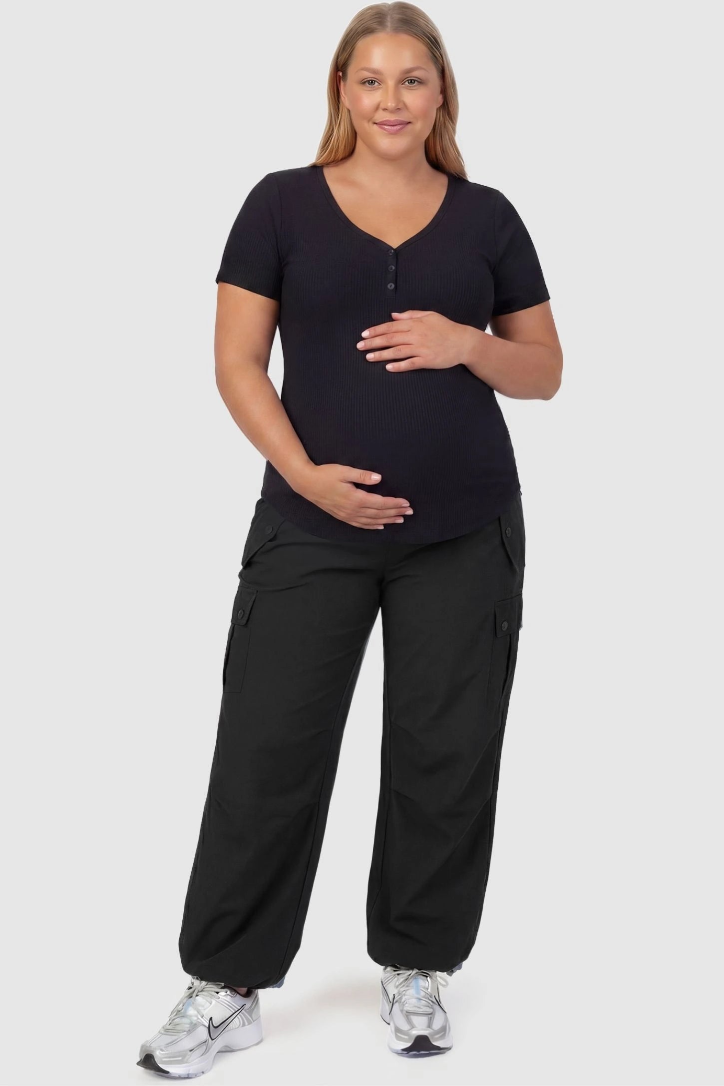 Ice Silk Cargo Maternity Pants Ice Silk Cargo Maternity Pants in black featuring full belly panel, cargo pockets, and relaxed full-length fit on plus size pregnant model front view.