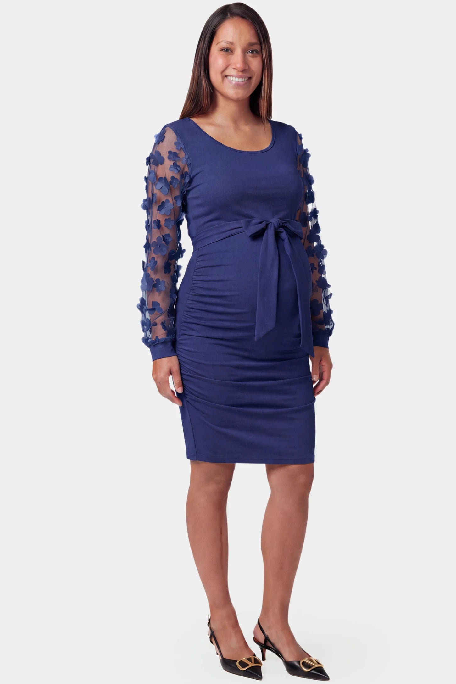 Sheer Long-Sleeve Tie-Waist Short Maternity Dress Sheer long-sleeve tie-waist short maternity dress in dark blue featuring waist sash in front view on a pregnant model