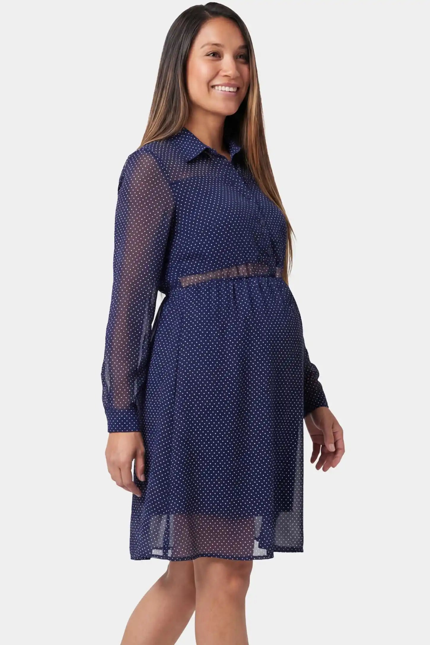 Shirt collar long sleeve V-neck short maternity and nursing dress in dark blue featuring sheer long-sleeves in side view on a pregnant model