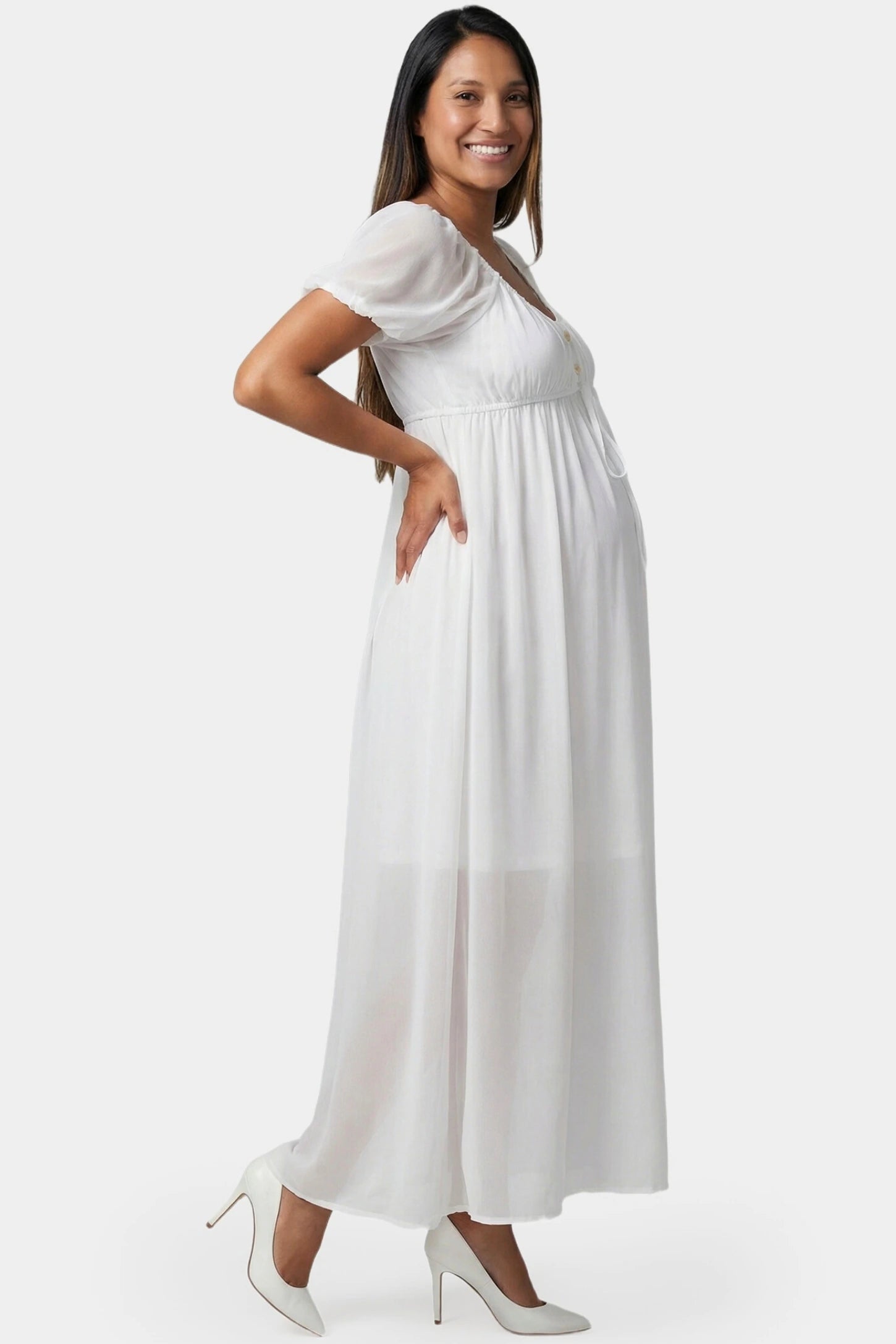Chiffon Puff Sleeve Scoop Neck Maxi Maternity Dress in white featuring flowing full skirt in full body side view on a pregnant model