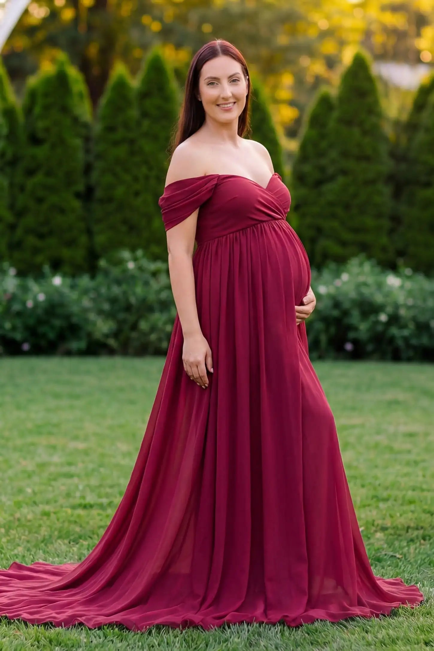 Chiffon-Finish Flowing Off-The-Shoulder Maternity Photoshoot Gown Burgundy Chiffon-Finish Flowing Off-The-Shoulder Maternity Photoshoot Gown featuring an empire waist on a pregnant model.