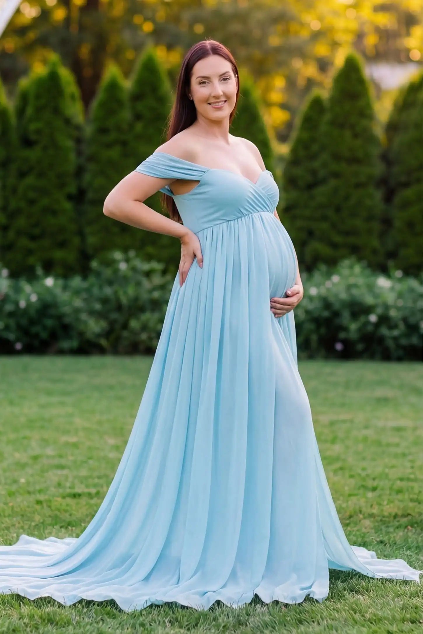 Chiffon-Finish Flowing Off-The-Shoulder Maternity Photoshoot Gown Light Blue Chiffon-Finish Flowing Off-The-Shoulder Maternity Photoshoot Gown featuring an empire waist on a pregnant model.
