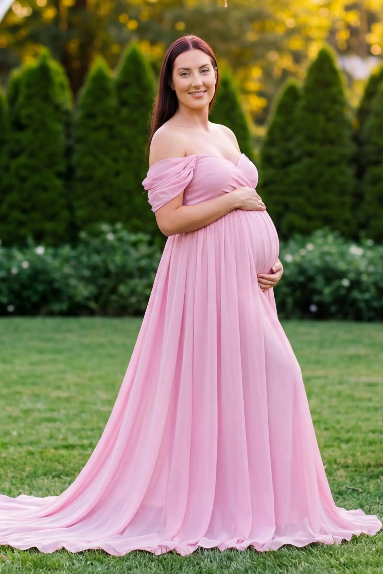 Chiffon-Finish Flowing Off-The-Shoulder Maternity Photoshoot Gown Pink Chiffon-Finish Flowing Off-The-Shoulder Maternity Photoshoot Gown featuring an empire waist on a pregnant model.