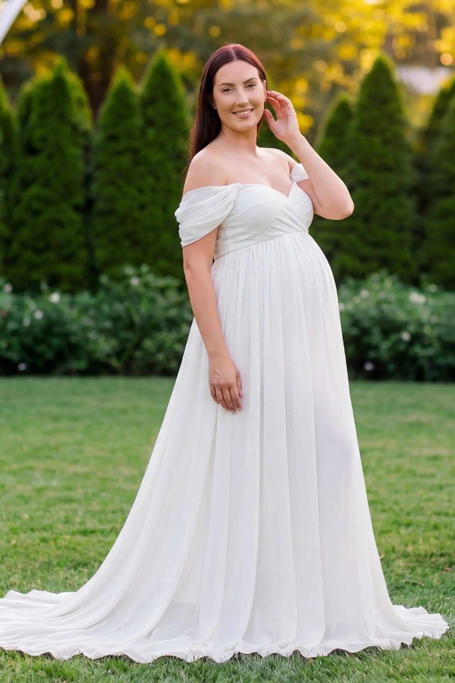 Chiffon-Finish Flowing Off-The-Shoulder Maternity Photoshoot Gown White Chiffon-Finish Flowing Off-The-Shoulder Maternity Photoshoot Gown featuring a sweetheart neck on a pregnant model outdoors.