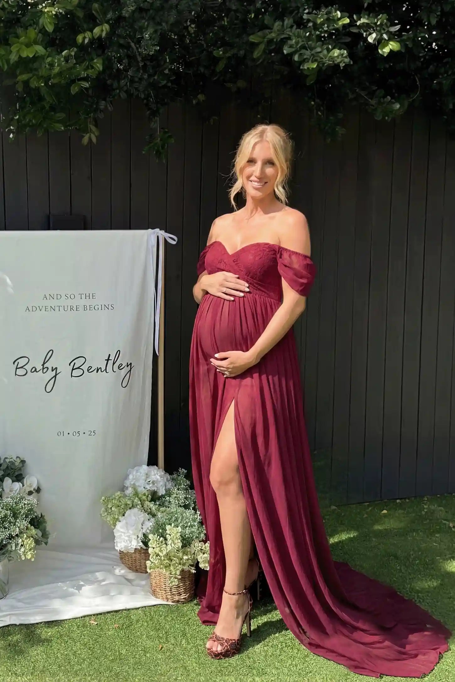 Chiffon Split-Front Maxi Maternity Photoshoot Gown Chiffon Split-Front Maxi Maternity Photoshoot Dress in Burgundy featuring a luxurious tiered skirt on a pregnant model outdoors.
