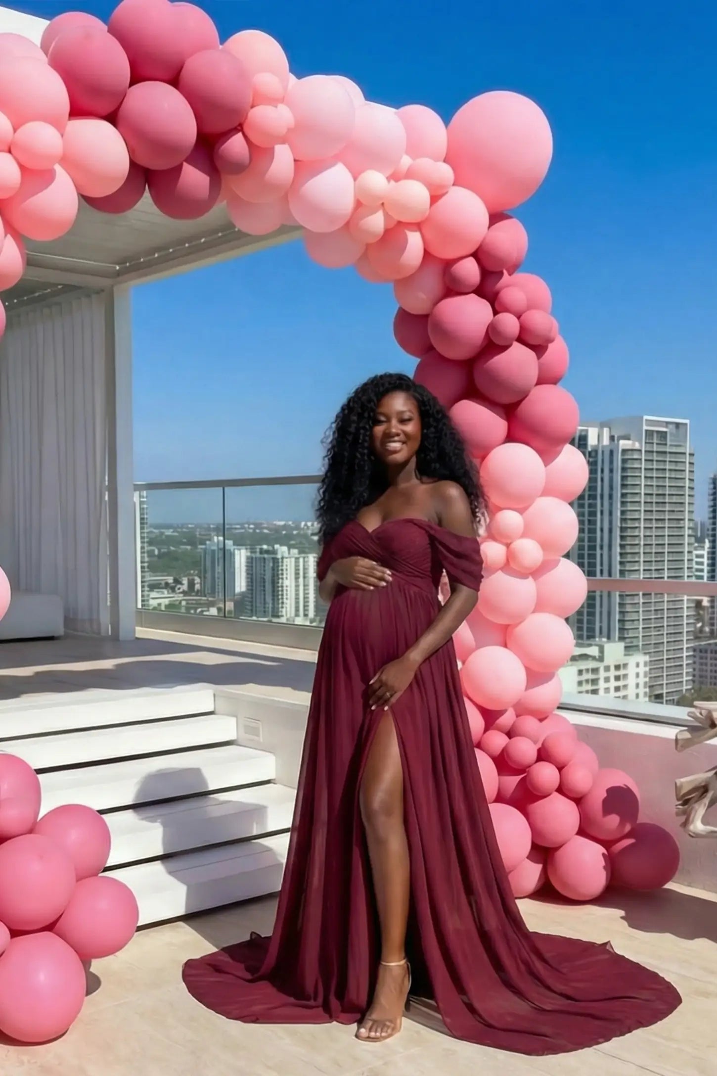 Chiffon Split-Front Maxi Maternity Photoshoot Gown Chiffon Split-Front Maxi Maternity Photoshoot Dress in Burgundy featuring romantic lace details on a pregnant model at a baby shower.