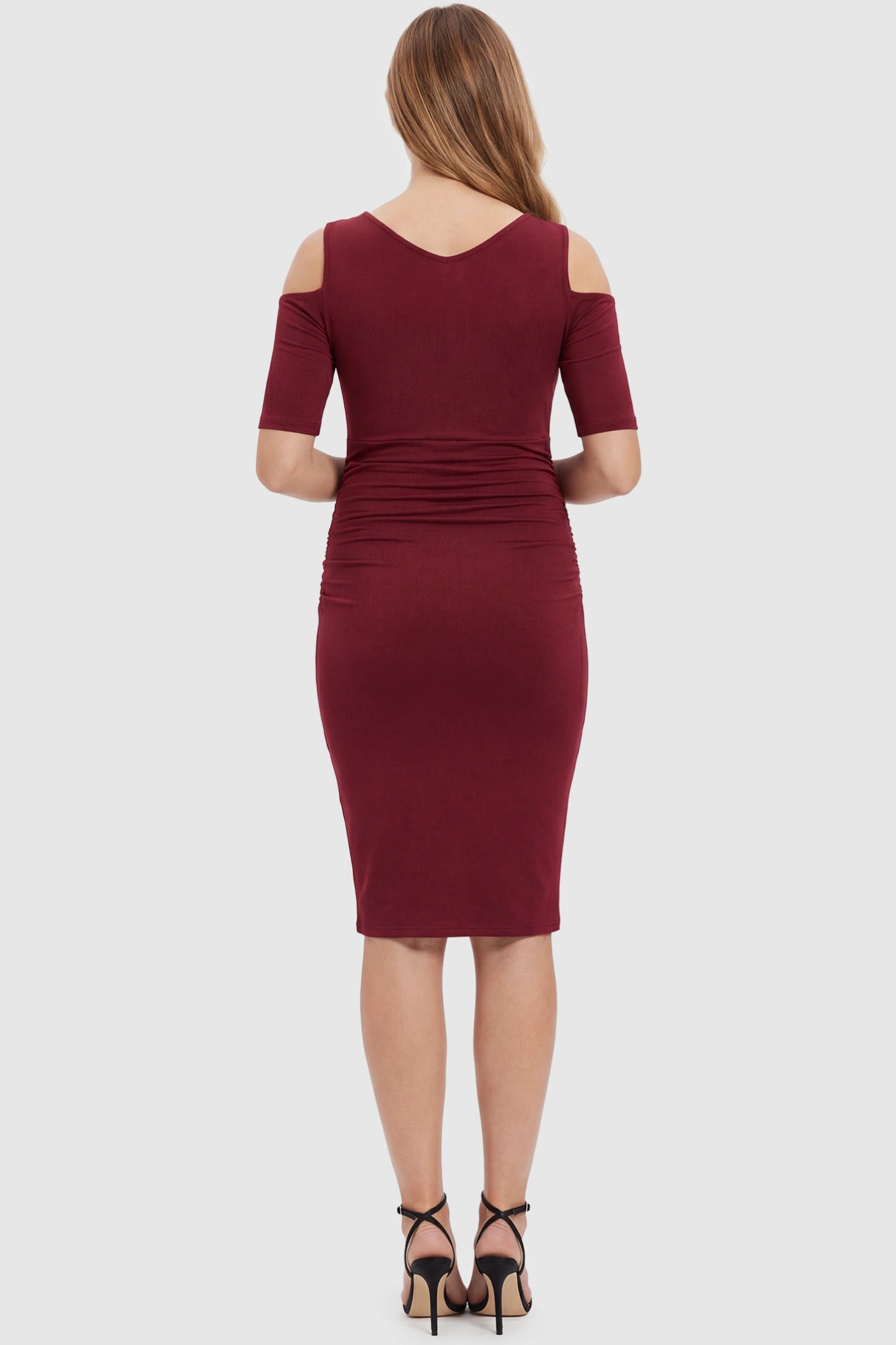 Cold Shoulder Sleeve Fitted Short Maternity Dress Cold shoulder sleeve fitted short maternity dress in burgundy featuring soft stretch fabric in full body back view on a pregnant model
