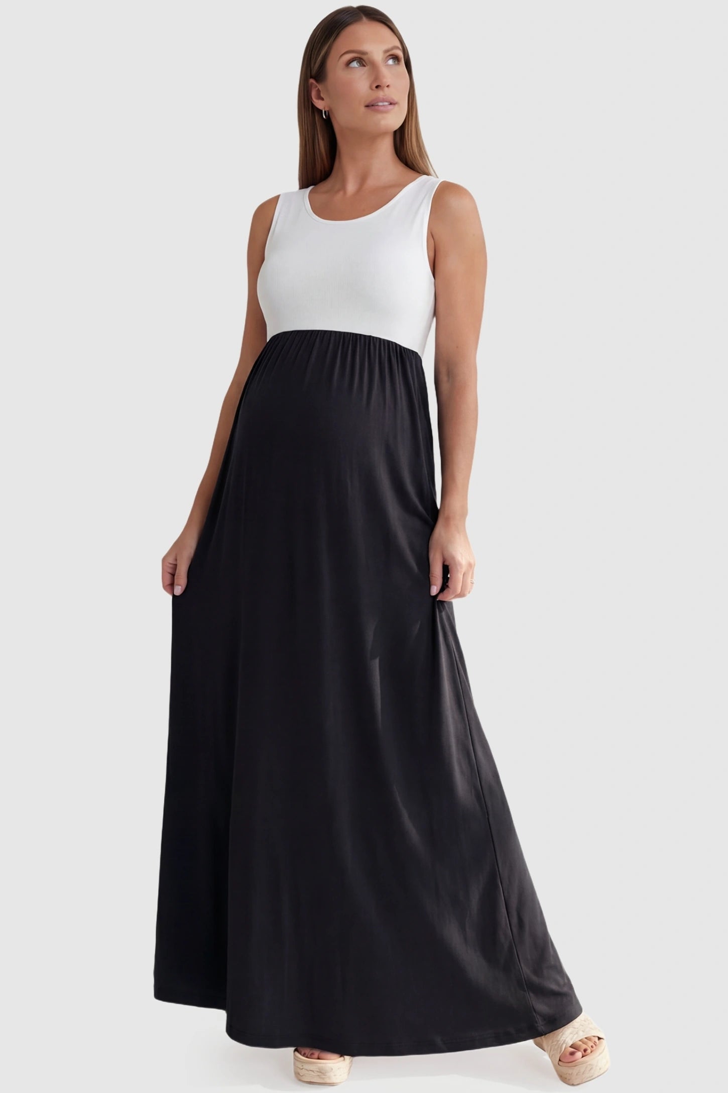 Color-Block Sleeveless Maternity Maxi Dress Color-Block Sleeveless Maternity Maxi Dress in Black featuring a contrast bodice on a pregnant model.