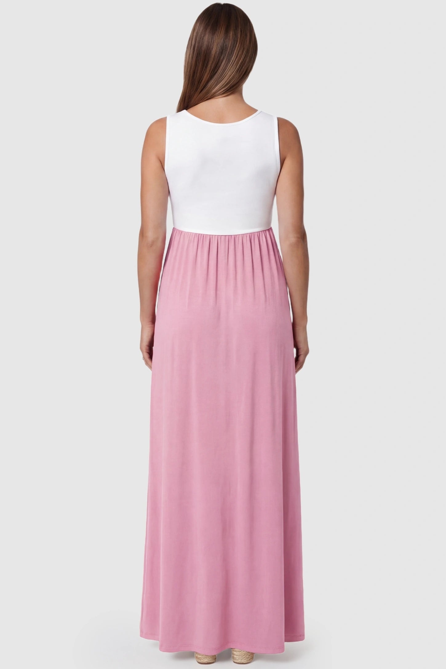 Color-Block Sleeveless Maternity Maxi Dress Color-Block Sleeveless Maternity Maxi Dress in Pink featuring a clean sleeveless cut on a pregnant model.