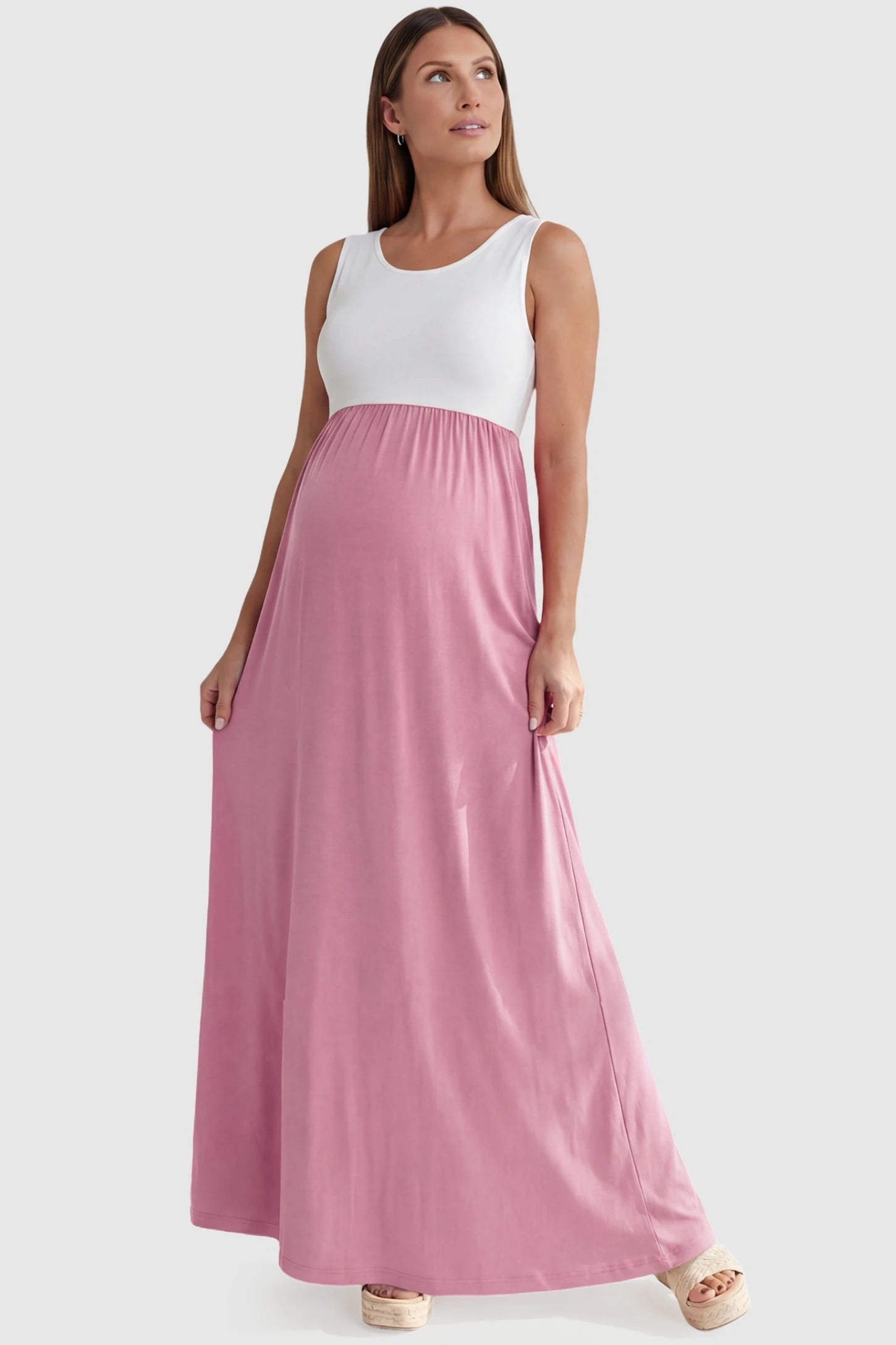 Color-Block Sleeveless Maternity Maxi Dress Color-Block Sleeveless Maternity Maxi Dress in Pink featuring a stretchy empire waist on a pregnant model.