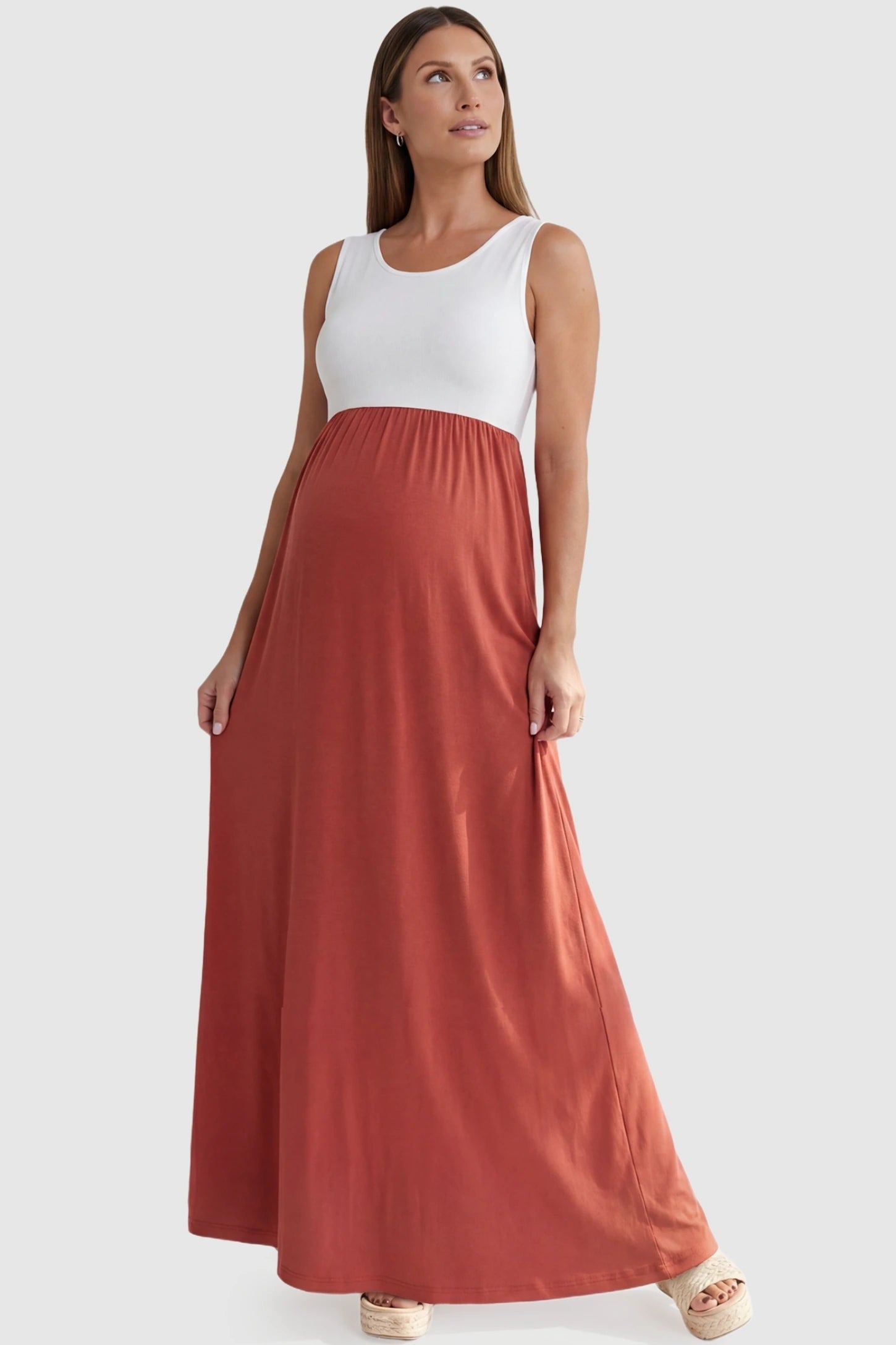 Color-Block Sleeveless Maternity Maxi Dress Color-Block Sleeveless Maternity Maxi Dress in Rose featuring a dual-tone design on a pregnant model