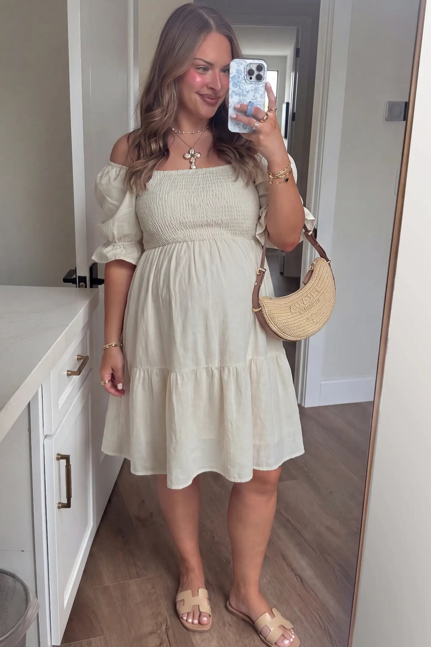 Smocked Off-Shoulder Empire Waist Maternity Short Dress Smocked off-shoulder empire waist maternity short dress in khaki with smocked bodice detail, front view on pregnant model