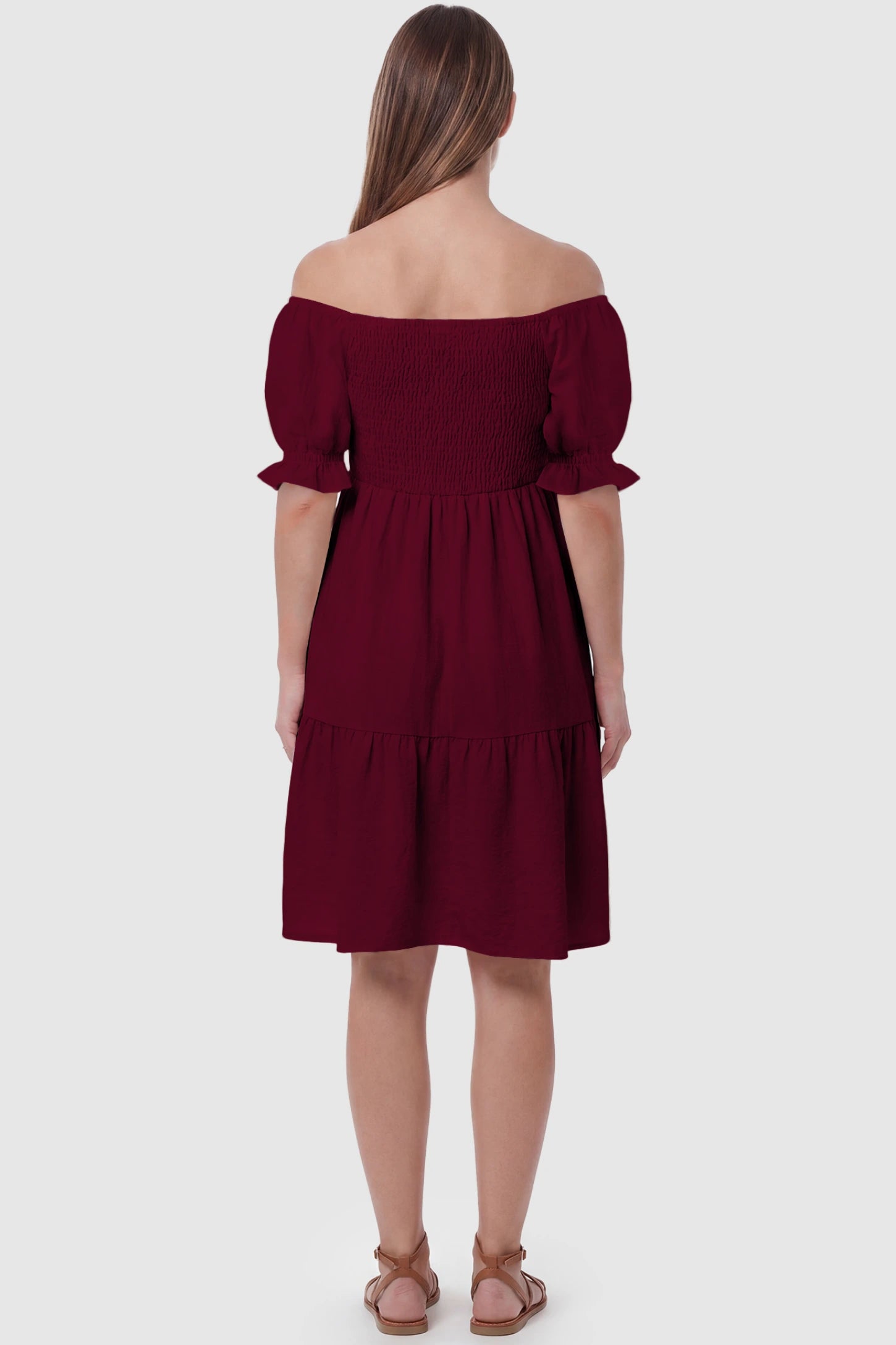 Smocked Off-Shoulder Empire Waist Maternity Short Dress Smocked off-shoulder empire waist maternity short dress in wine red with short puff sleeve, back view on pregnant model