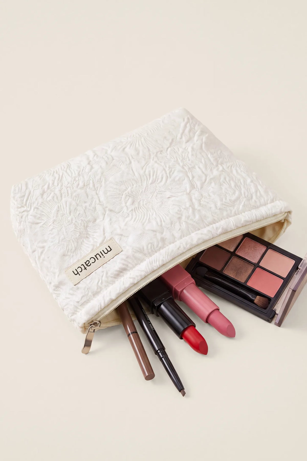 Corduroy Color-Block Travel Pouch Corduroy Color-Block Travel Pouch in Off-White Rose showing open main compartment storing makeup brushes, lipsticks, and eyeshadow palette, flat lay view.