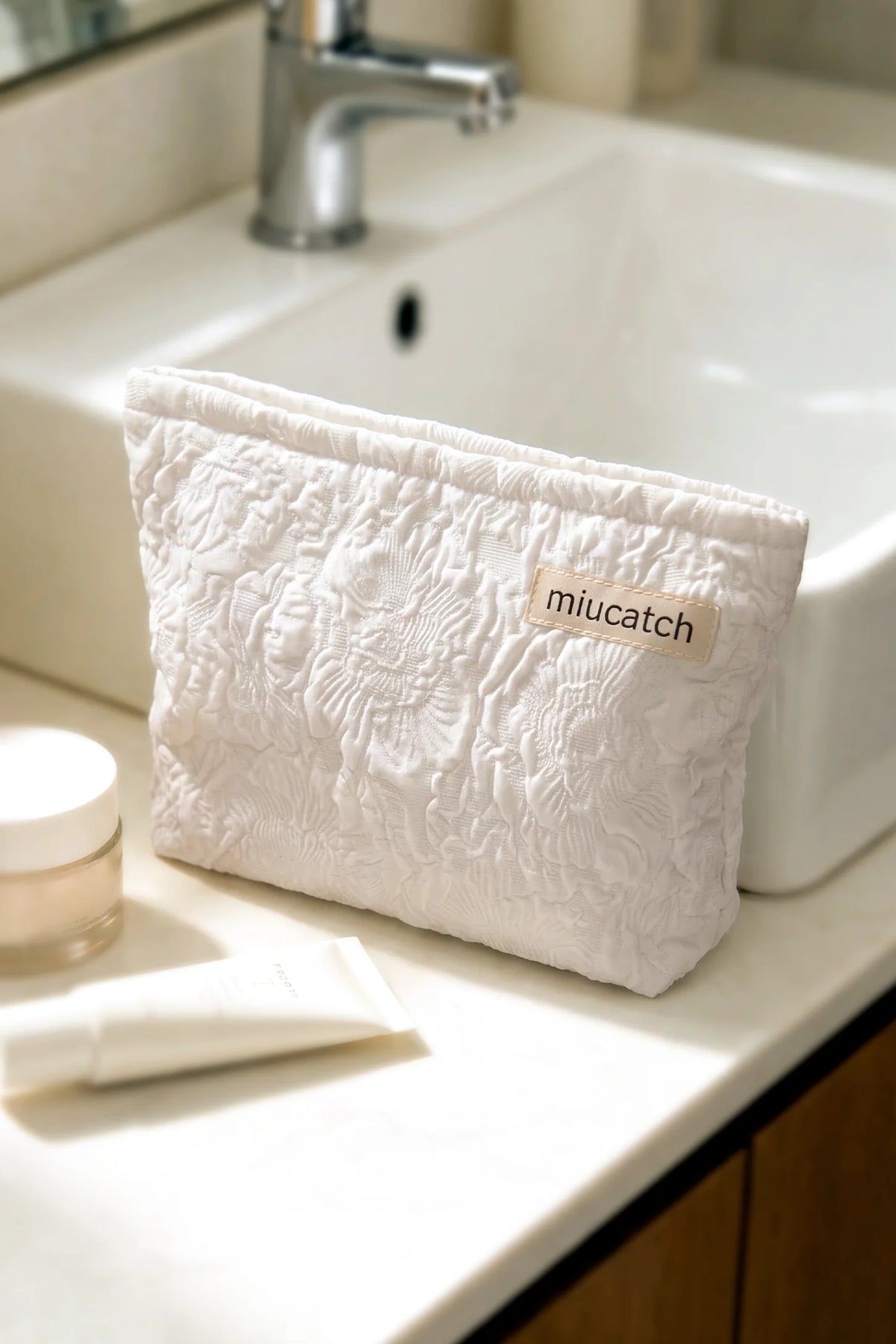 Corduroy Color-Block Travel Pouch Corduroy Color-Block Travel Pouch in Off-White Rose featuring textured double-layer corduroy structure resting beside a bathroom sink, home lifestyle view.