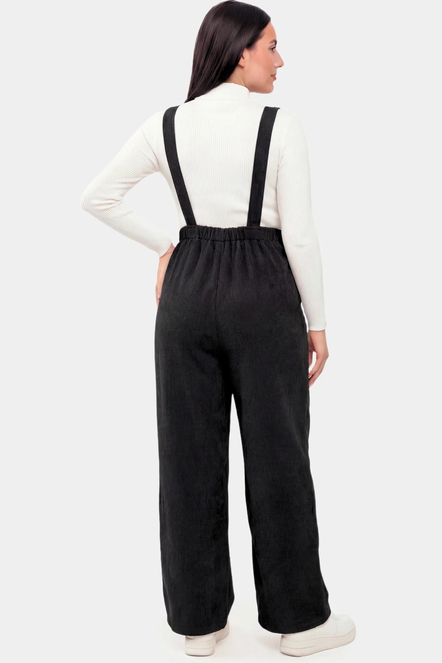 Corduroy Wide Leg Maternity Jumpsuit Corduroy Wide-Leg Maternity Jumpsuit in Black featuring a relaxed wide-leg silhouette on a pregnant model.