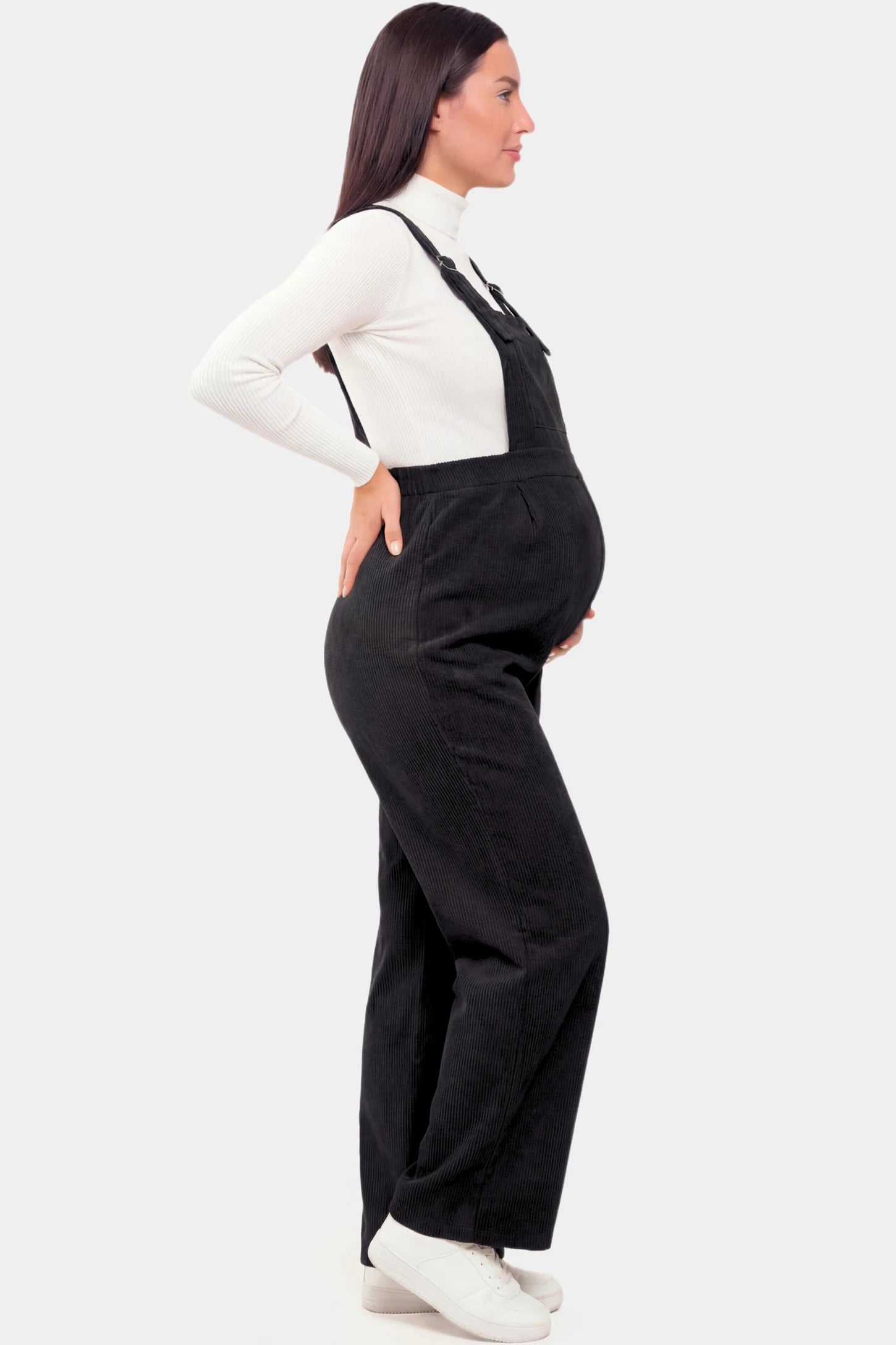 Corduroy Wide Leg Maternity Jumpsuit Corduroy Wide-Leg Maternity Jumpsuit in Black featuring a relaxed wide-leg silhouette on a pregnant model.