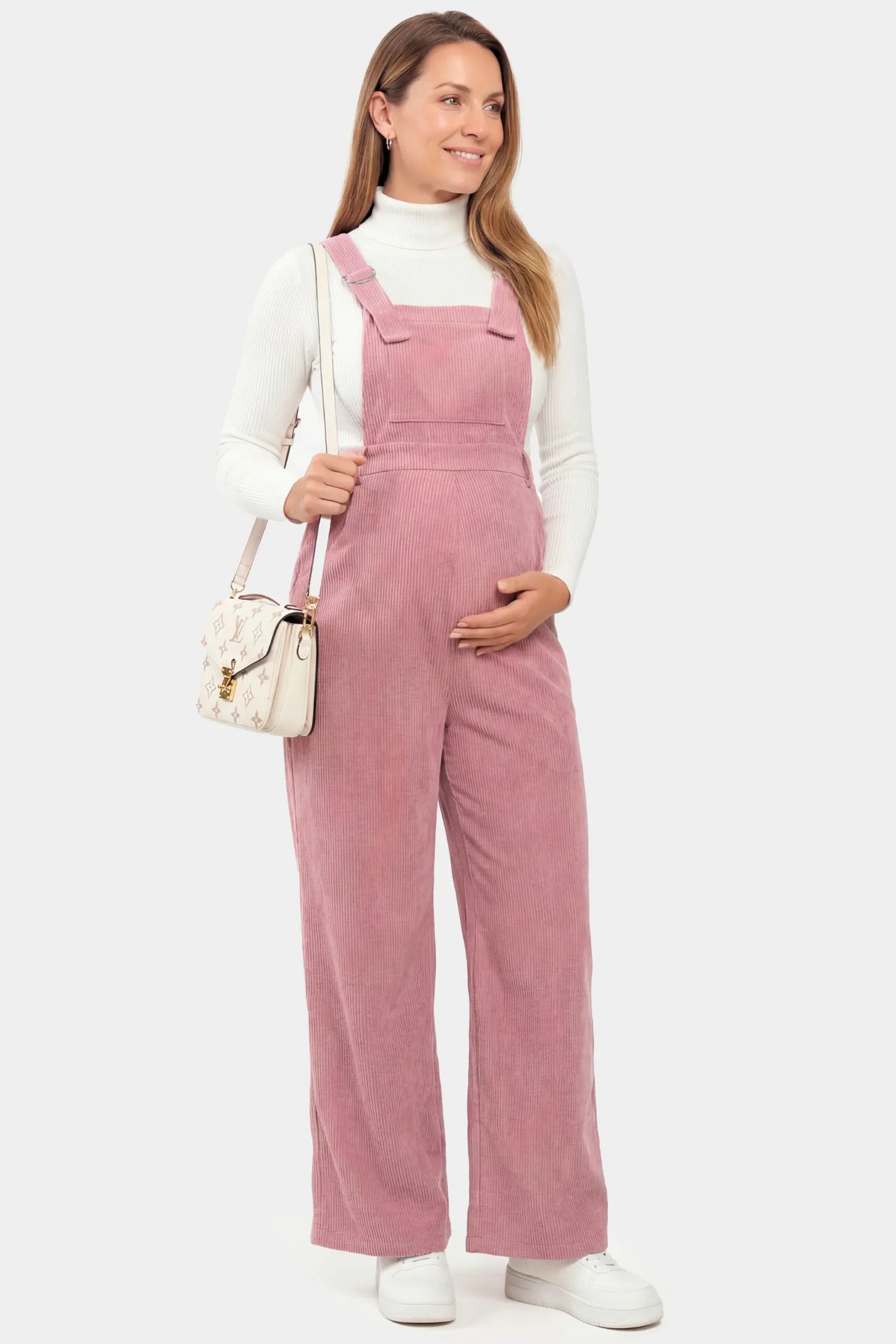 Corduroy Wide Leg Maternity Jumpsuit Corduroy Wide-Leg Maternity Jumpsuit in Pink featuring a relaxed wide-leg silhouette on a non pregnant model.