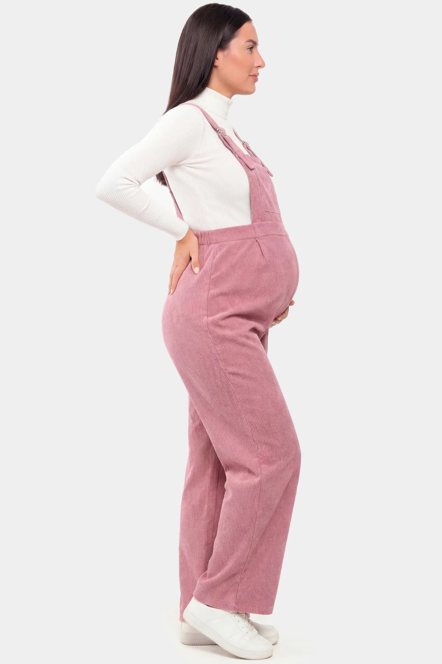 Corduroy Wide-Leg Maternity Jumpsuit in Pink featuring a relaxed wide-leg silhouette on a pregnant model.