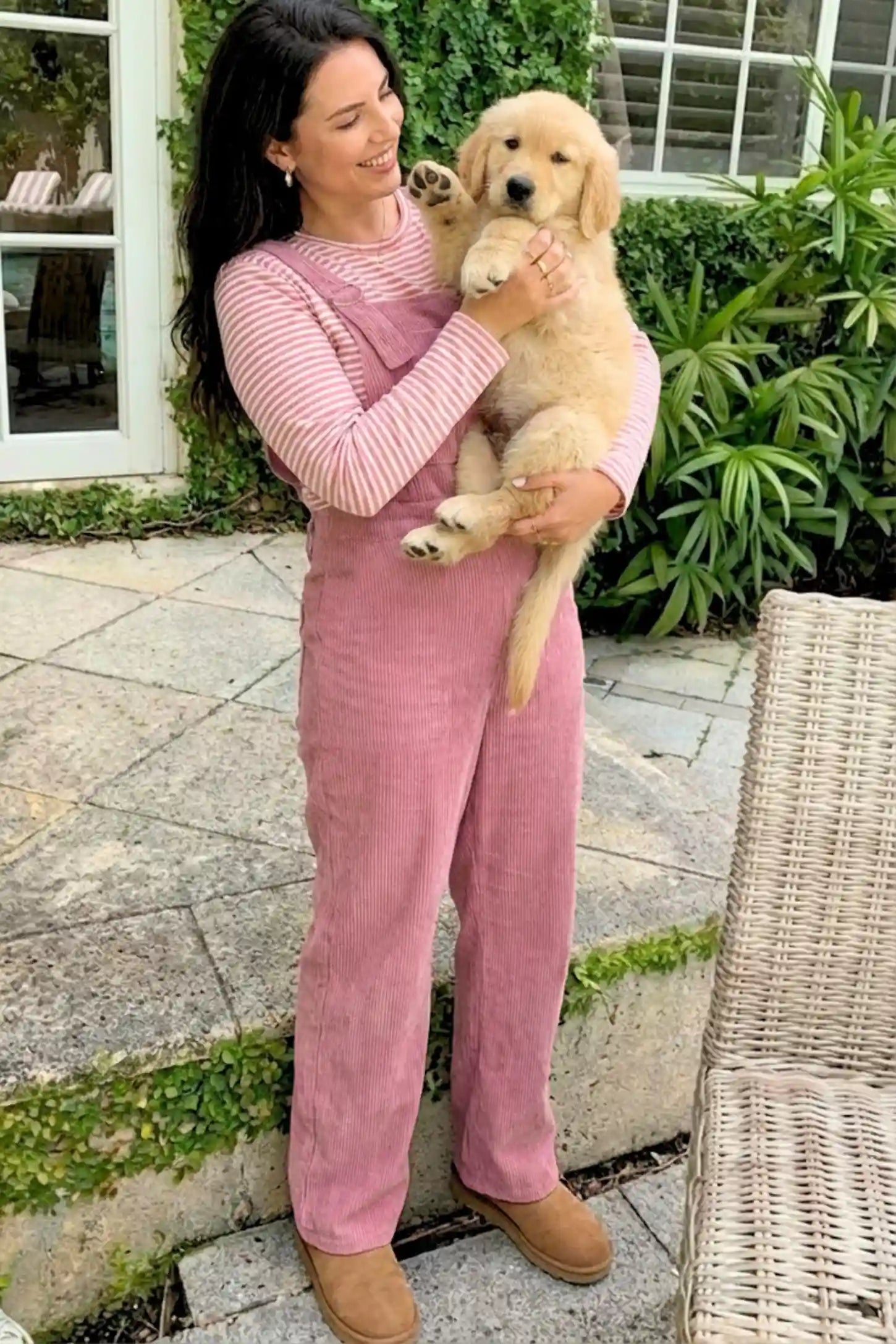 Corduroy Wide Leg Maternity Jumpsuit Corduroy Wide-Leg Maternity Jumpsuit in Pink featuring a relaxed wide-leg silhouette on a pregnant model.