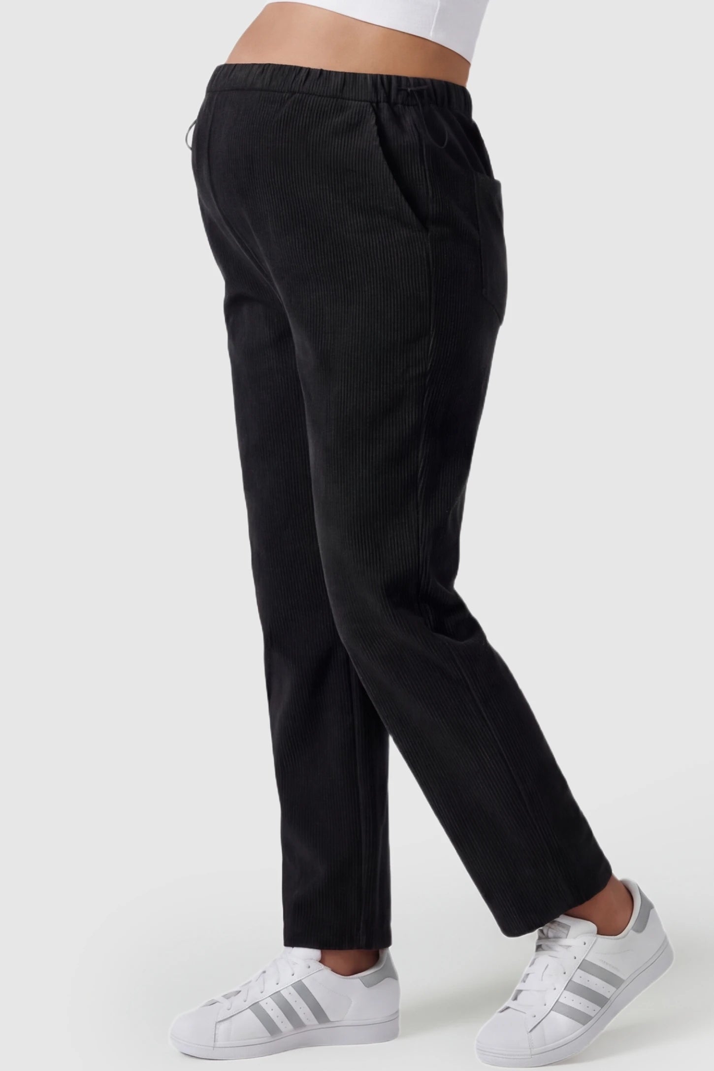 Corduroy Drawstring Waist Wide-Leg Maternity Pants Corduroy drawstring waist wide-leg maternity pants in black with functional side pockets, side view on pregnant model