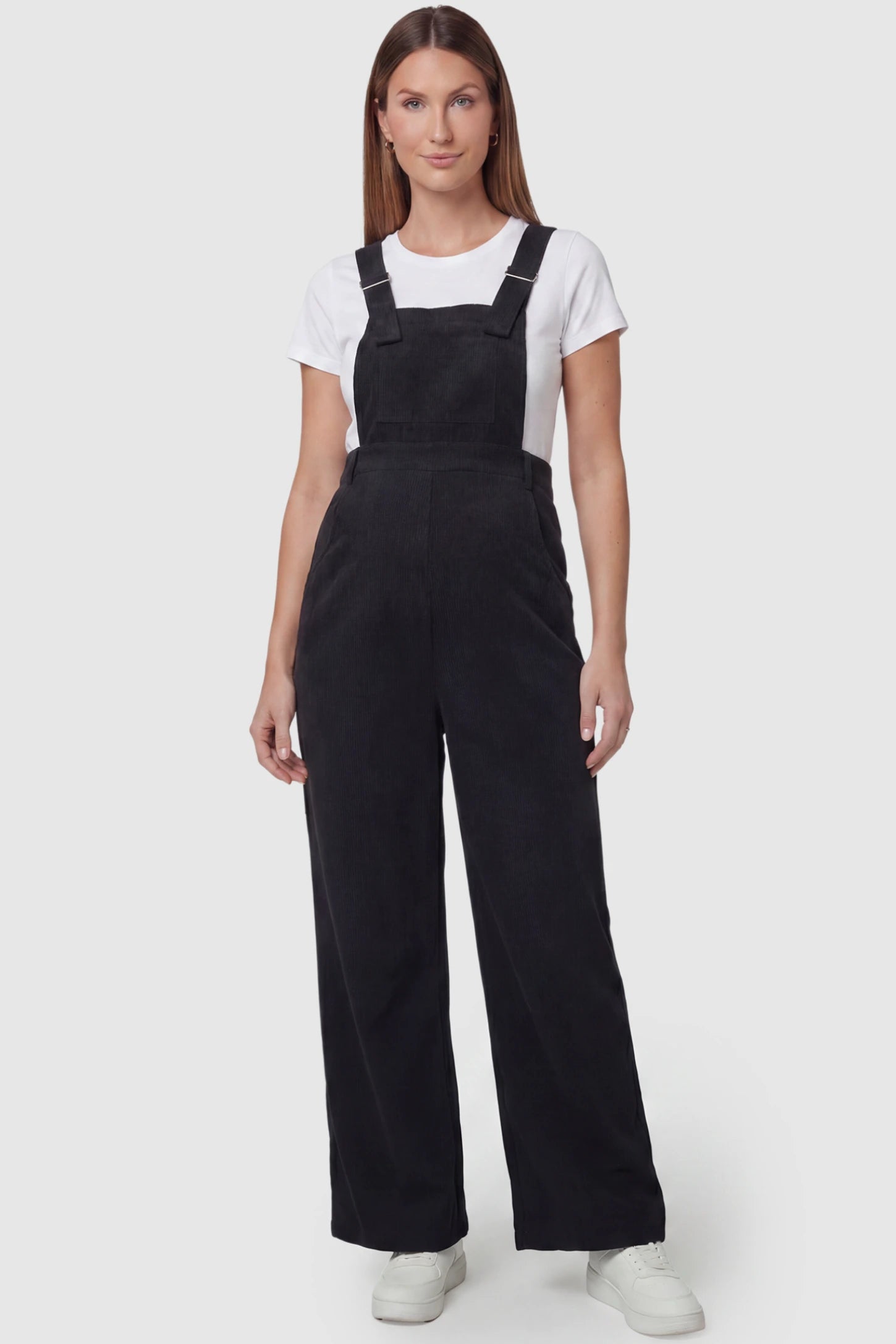 Corduroy Wide Leg Maternity Jumpsuit Corduroy Wide-Leg Maternity Jumpsuit in Black featuring a relaxed wide-leg silhouette on a pregnant model, front view.
